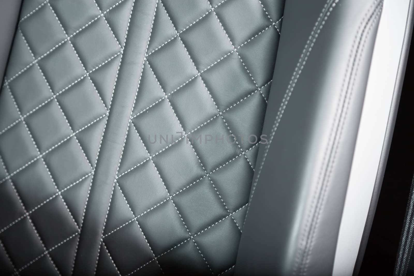 Close up of stitching on leather car seat by camerarules