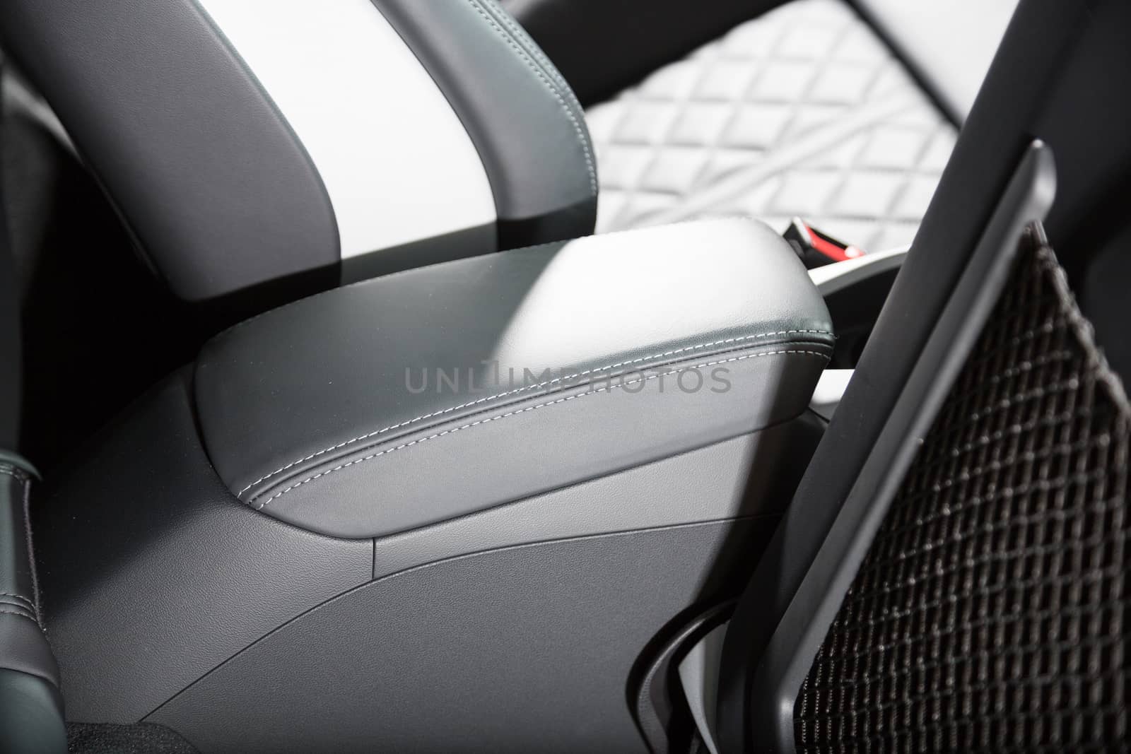 Close up of black leather arm rest in car interior