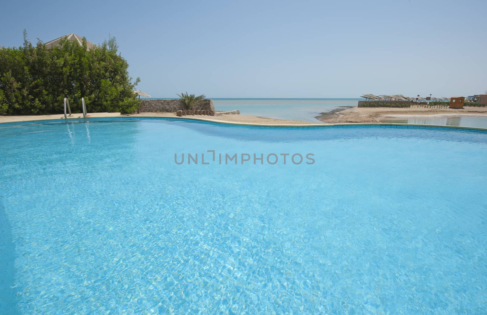 Luxury villa show home in tropical summer holiday resort with swimming pool and sea view