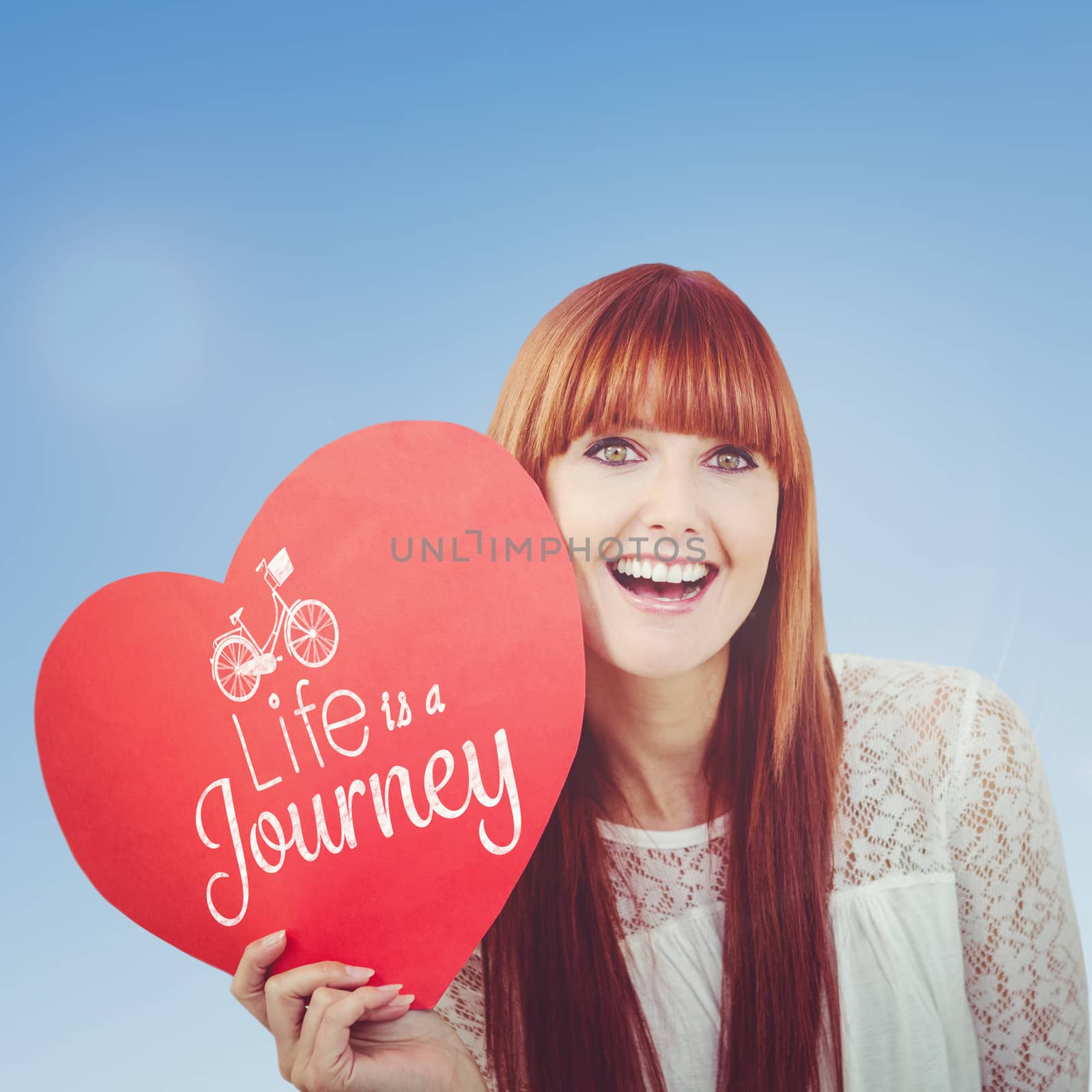 Smiling hipster woman with a big red heart against blue sky