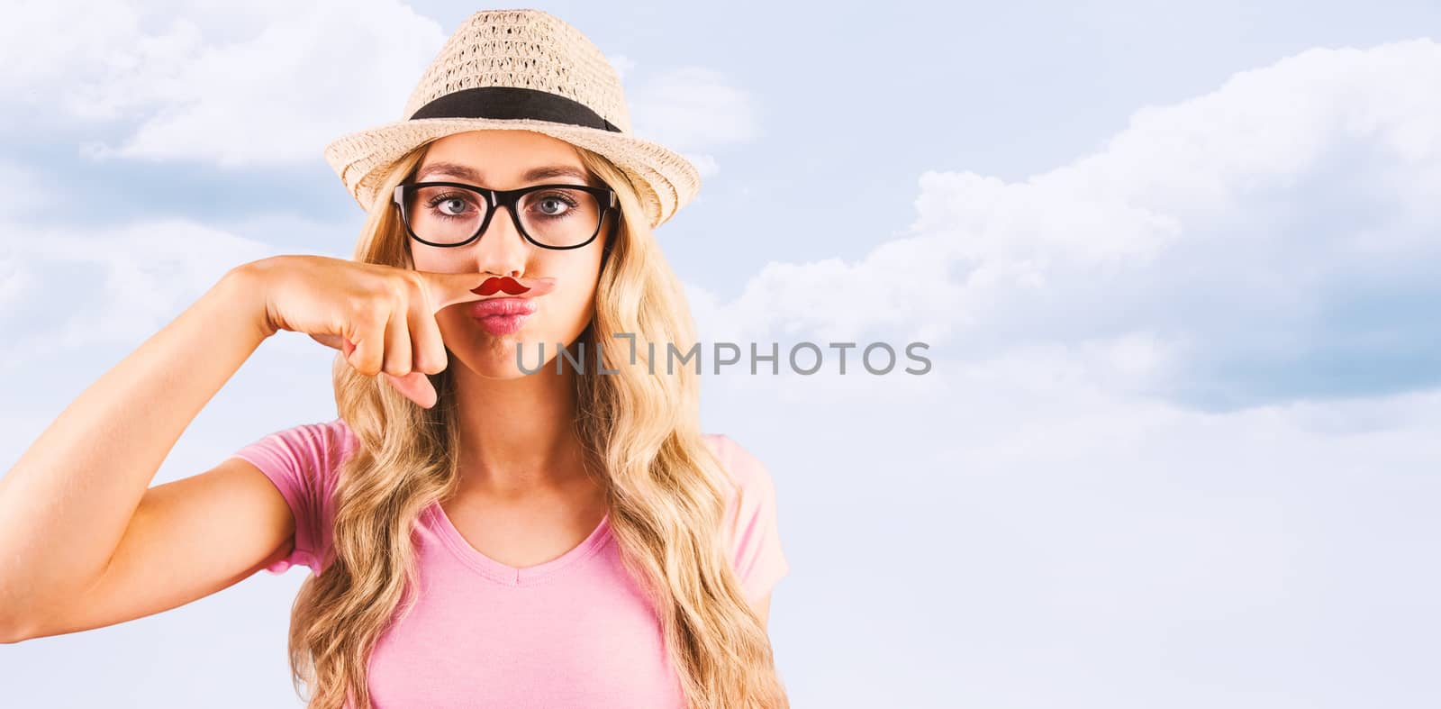 A beautiful hipster having a fake distinguished mustache  against blue sky