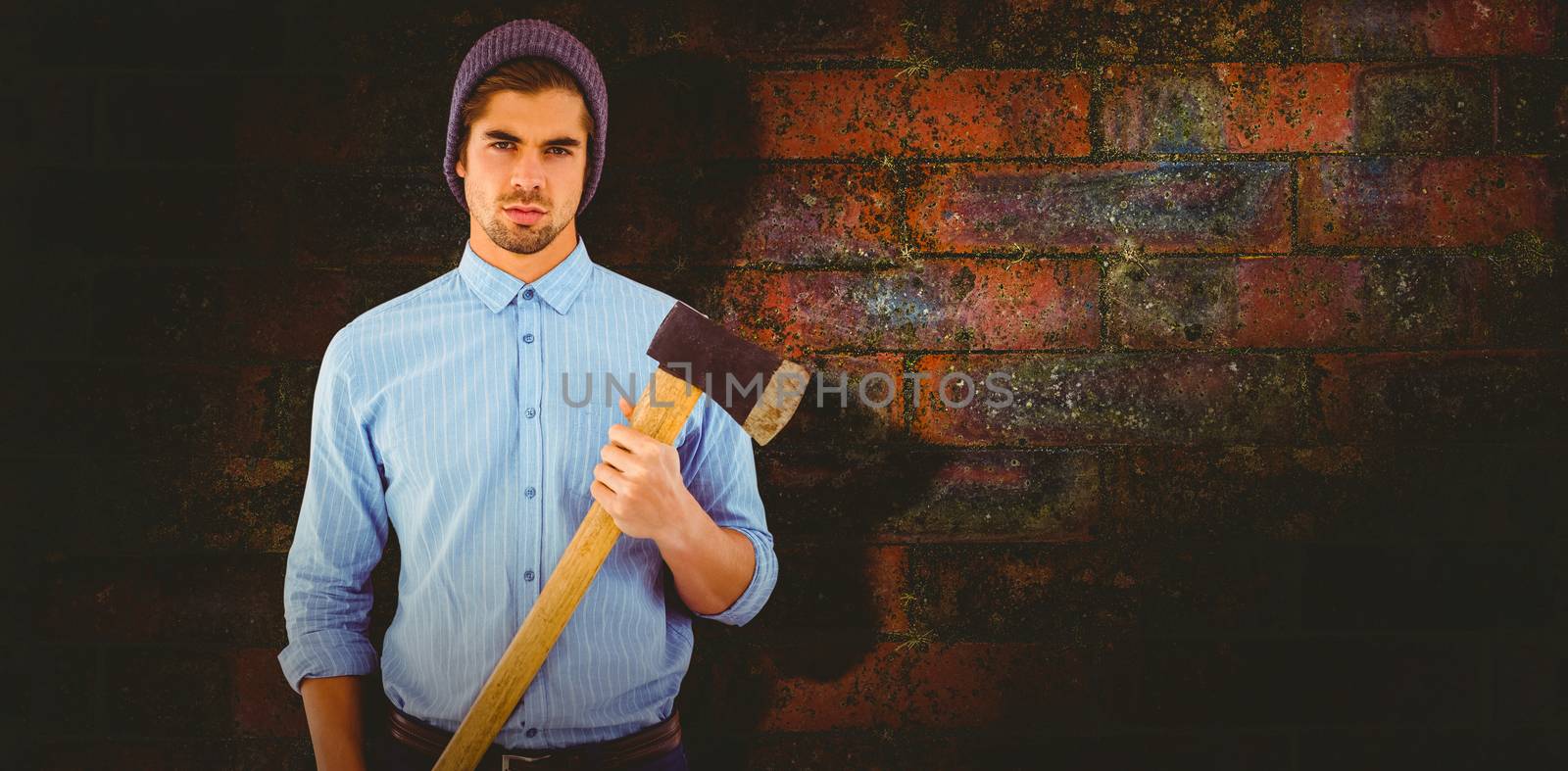 Composite image of portrait of serious hipster holding axe by Wavebreakmedia