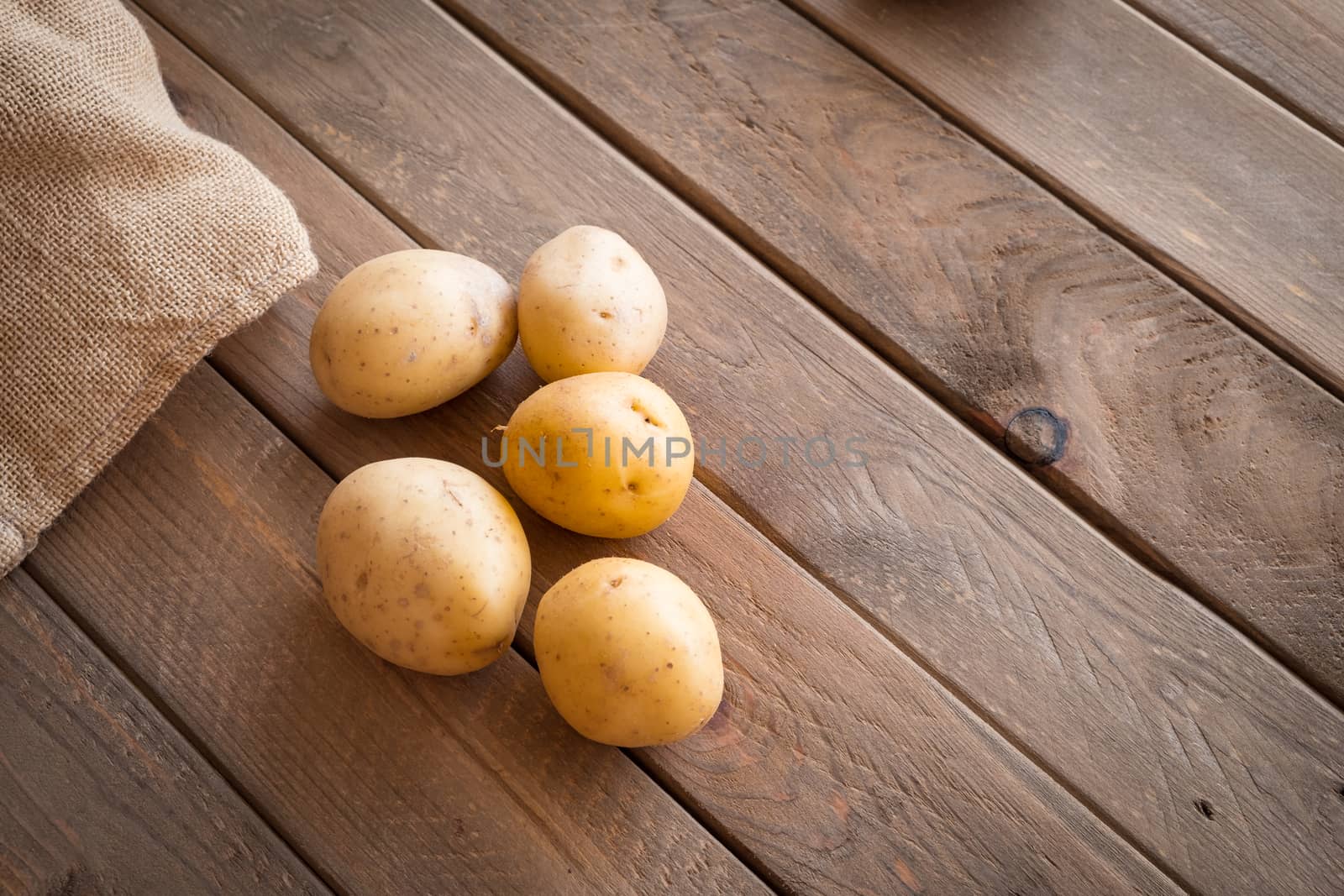 Potatoes ready for spanish omelet, view from above, on a rustic wooden texture