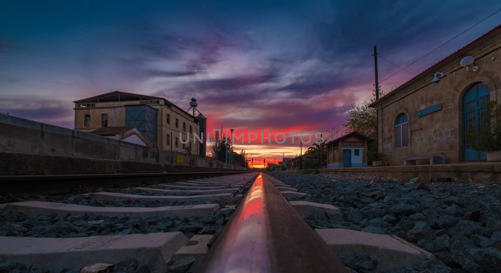 Sunset on the railroad, from a lined viewpoint with lane