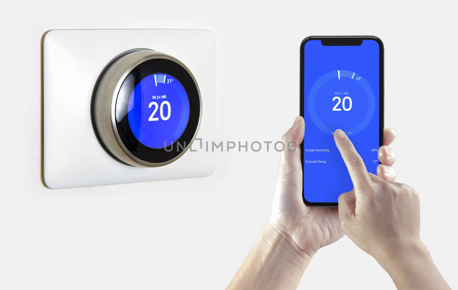 A person using a smart phone application cooling down the room temperature with a wireless smart thermostat on a white background. by oasisamuel