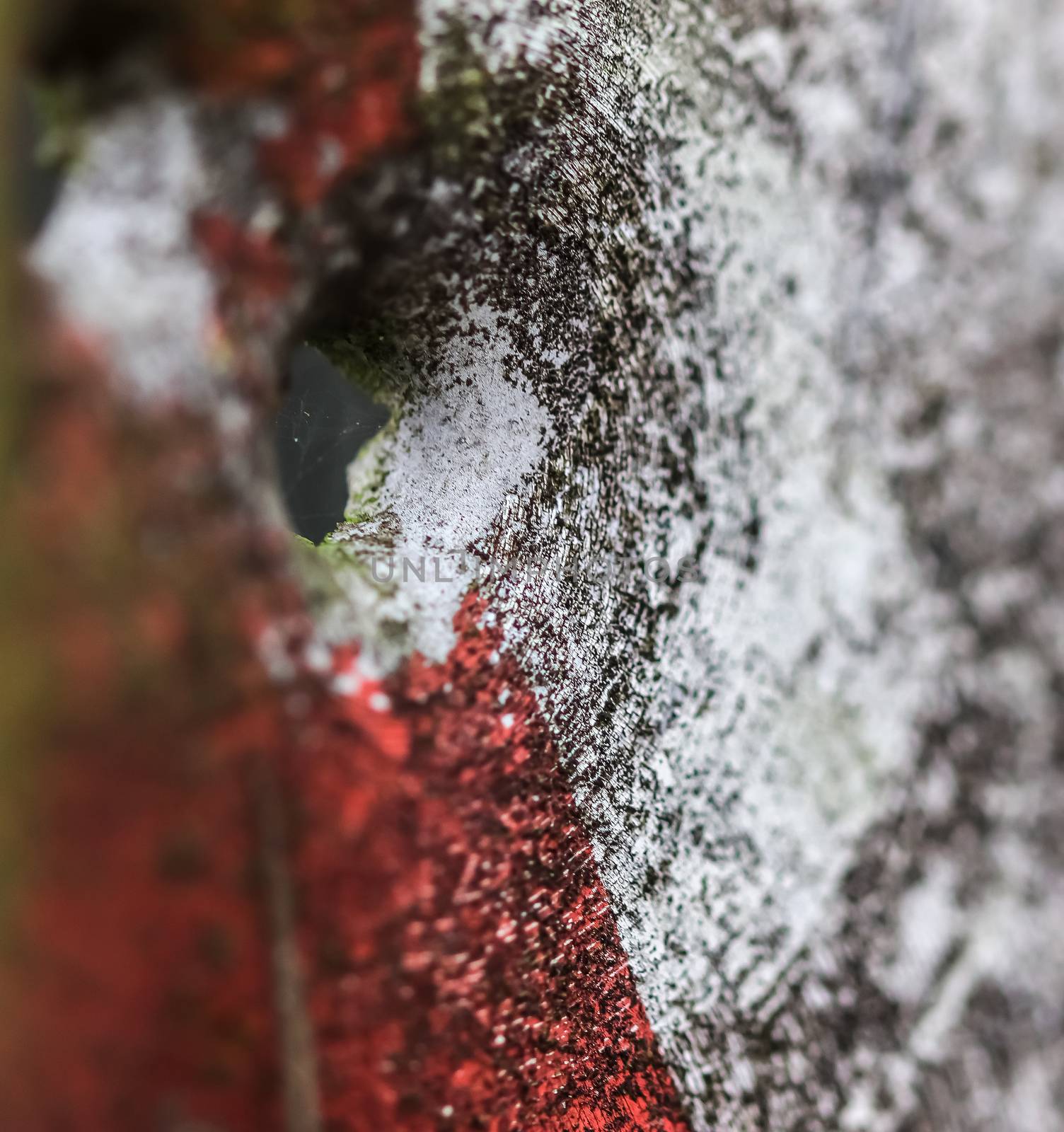 Detailed close up of bullet holes from gun shots in a german traffic sign