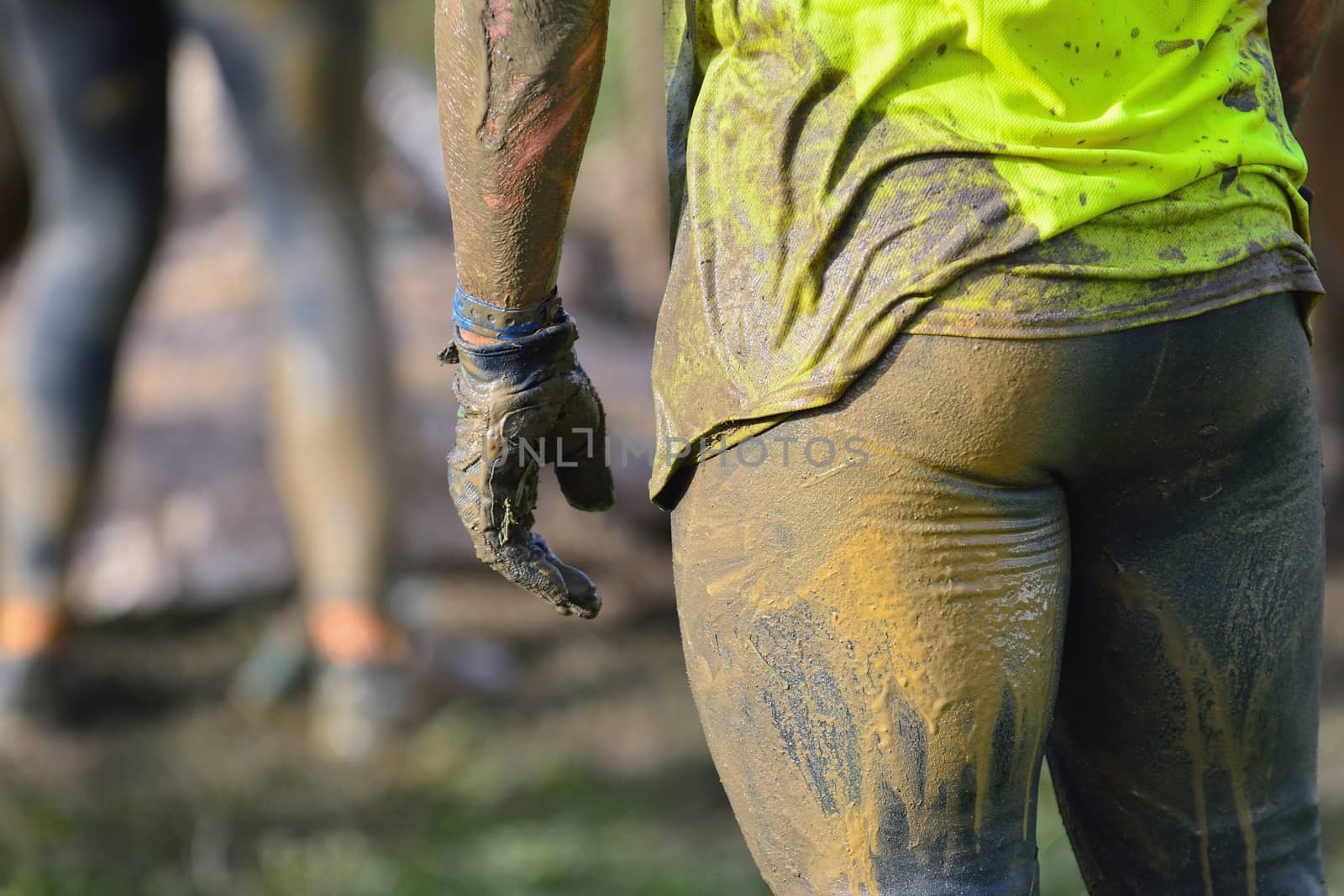 Back view of sportsman in dirty sportswear. Close-up. Unrecognizable