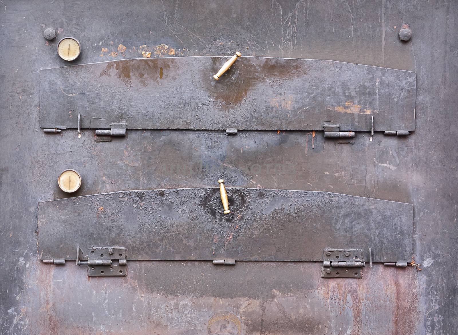 Close-up of closed aged iron pizza oven