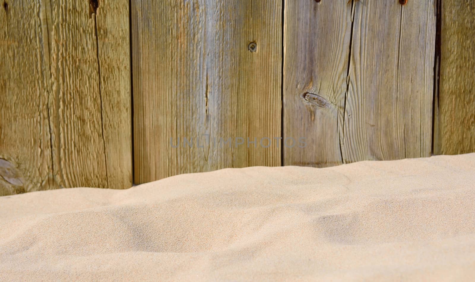 Wooden cracked boards. Sand on foreground