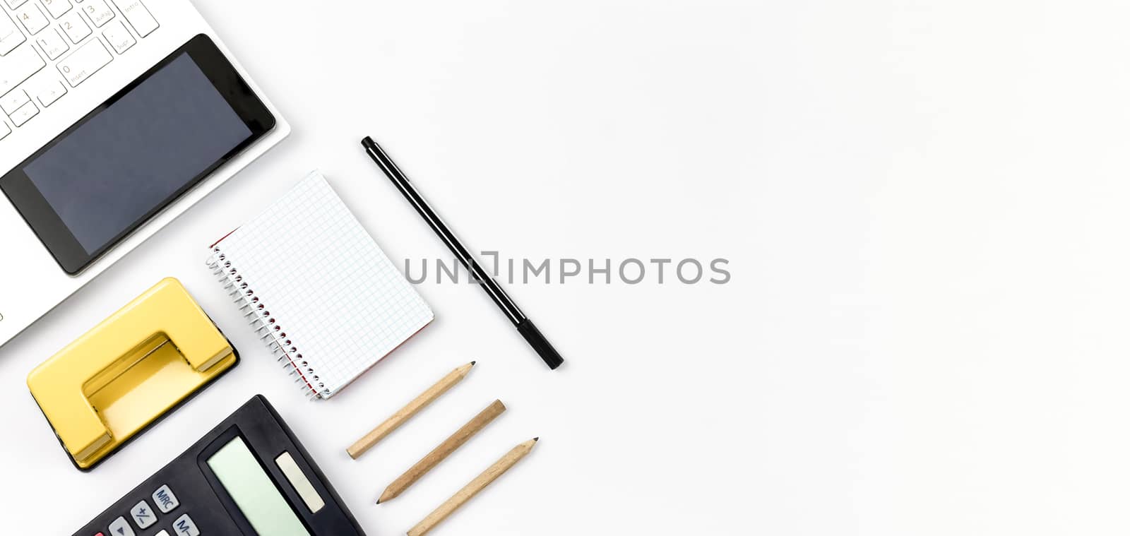 Laptop, Notebook and Office Supply Items on white Work Desk