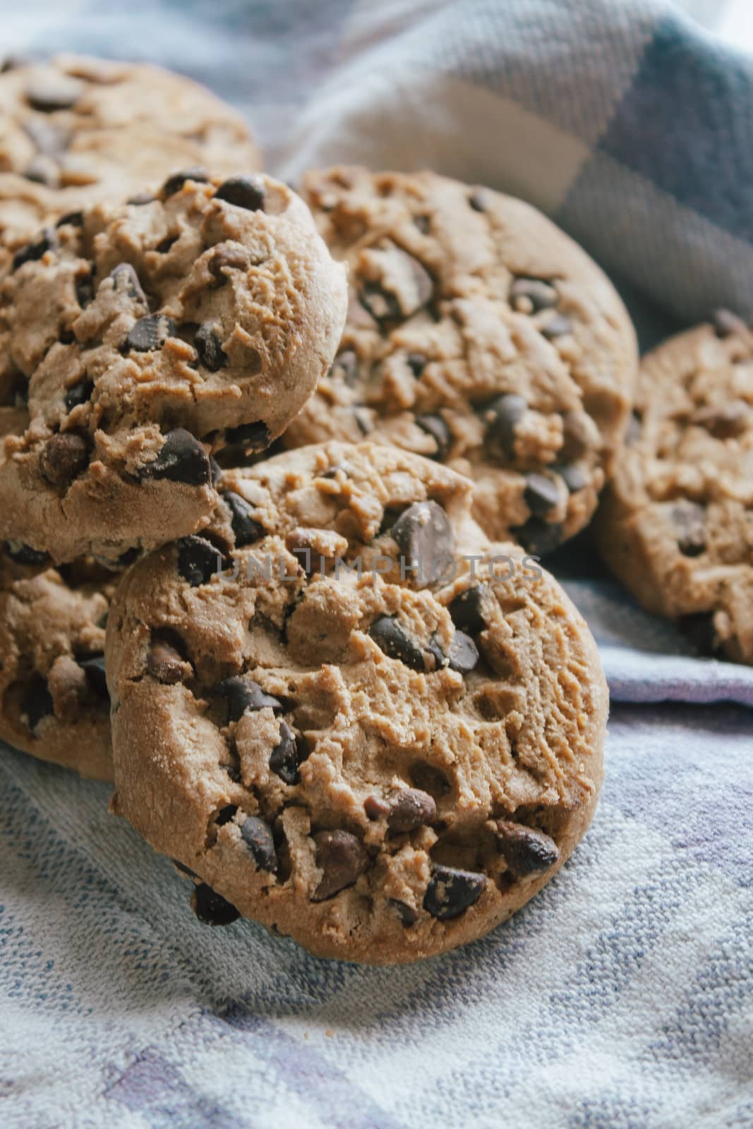 American chocolate cookies on blue cloth prepared for breakfast in the morning sunlight.Ideal for a tasty breakfast