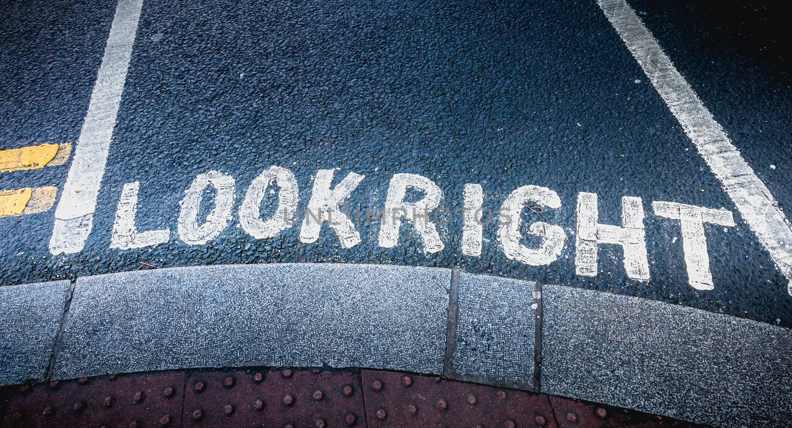 Look Right painted in white on the road on a pedestrian crossing in the city center on a winter day