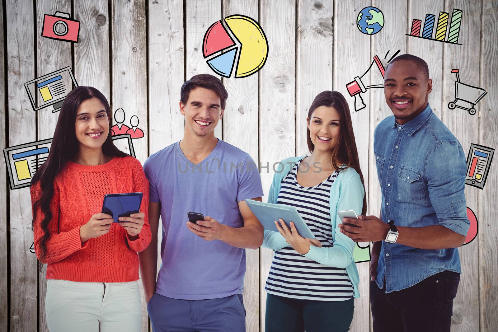 Composite image of young creative team looking at phones and tablets by Wavebreakmedia