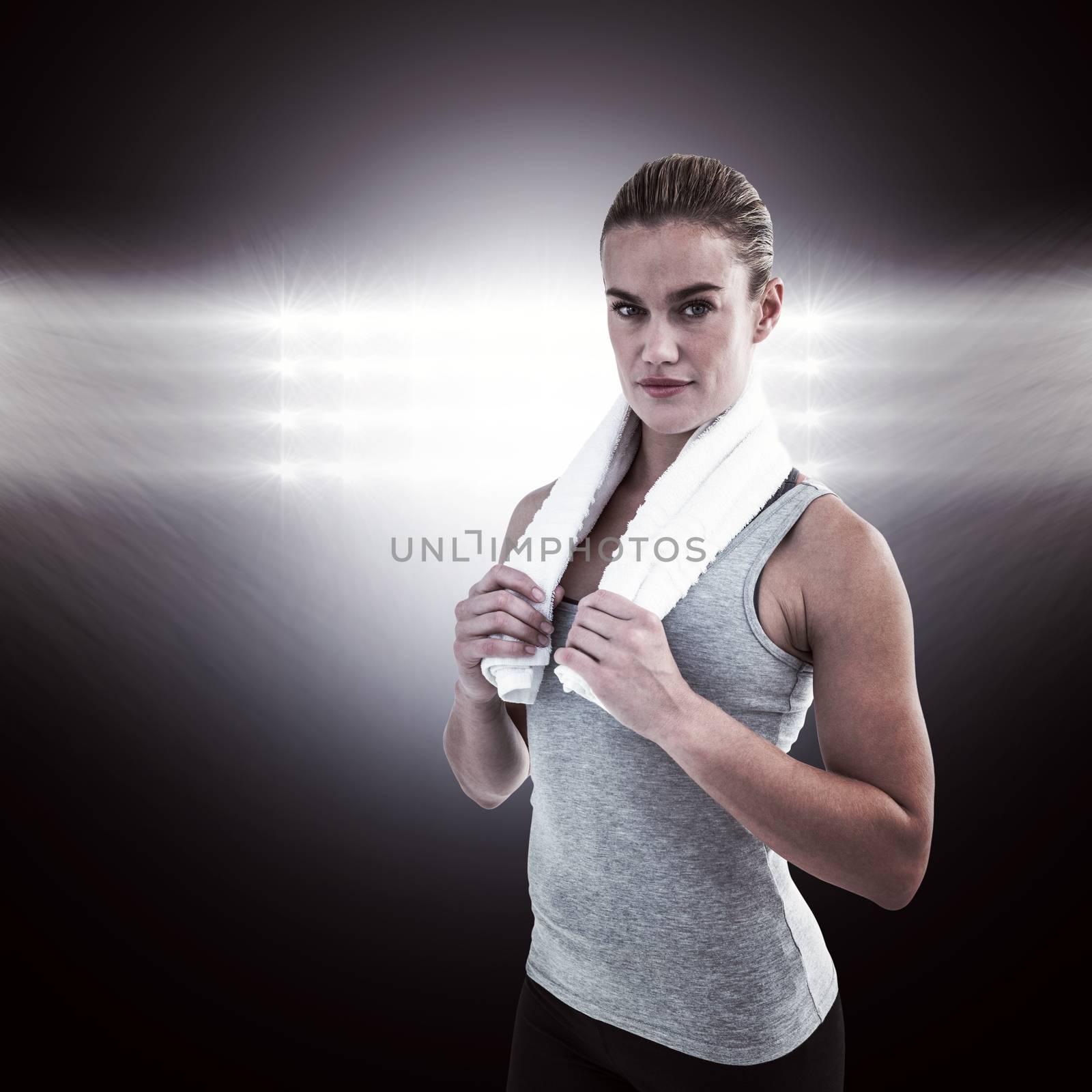 Composite image of muscular woman holding a towel around her neck by Wavebreakmedia