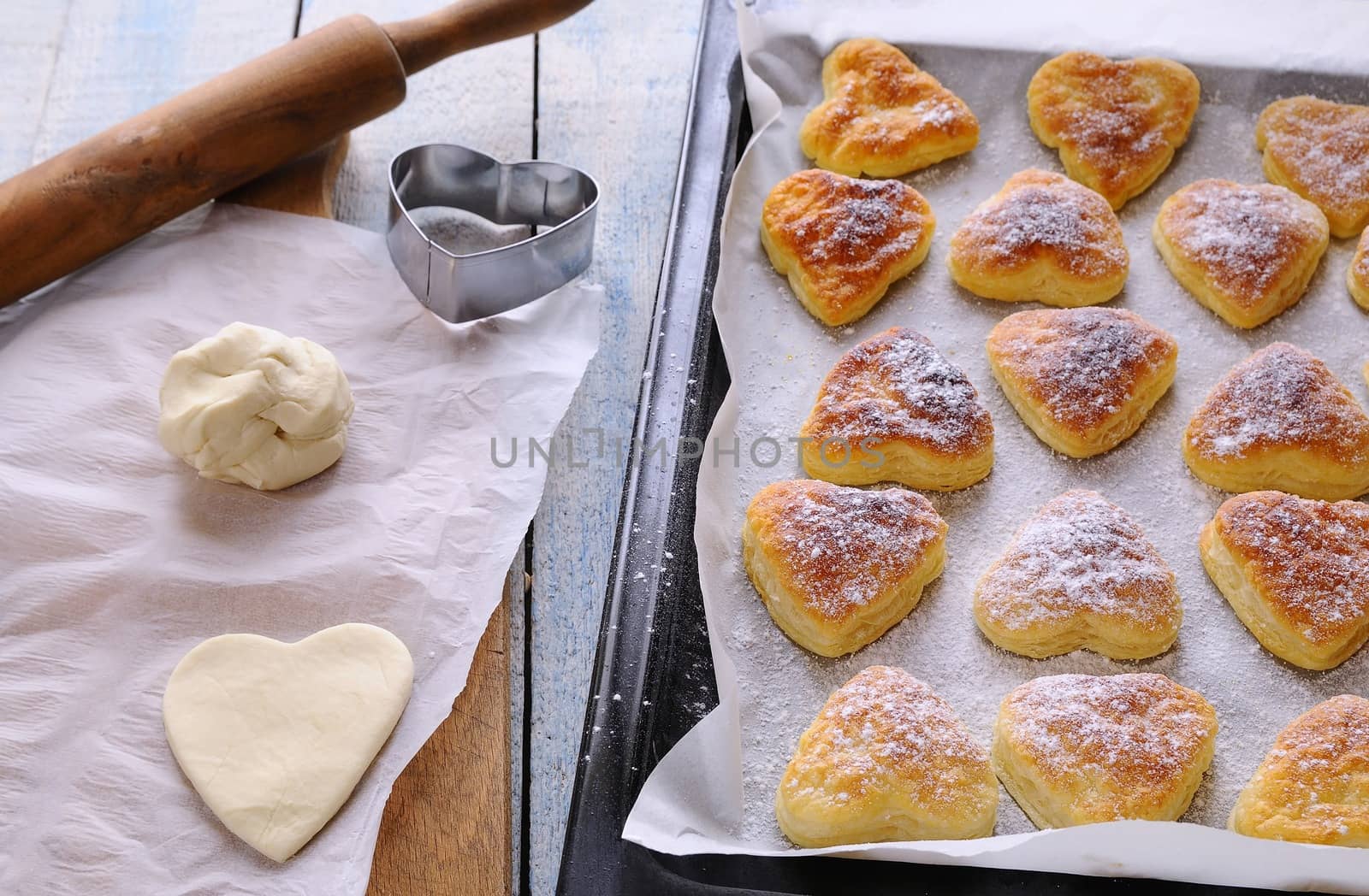 Heart-shaped puff pastry for valentines day over wooden table