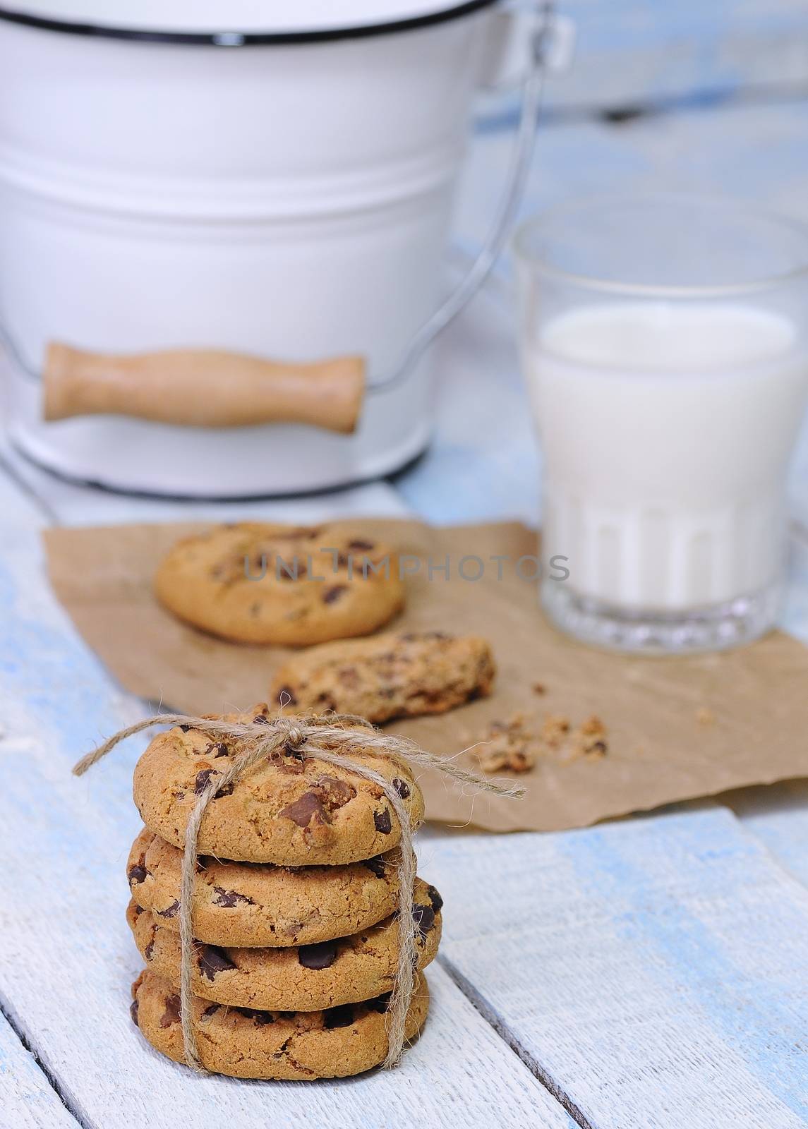 Homemade cookies with glass of milk on wooden table.