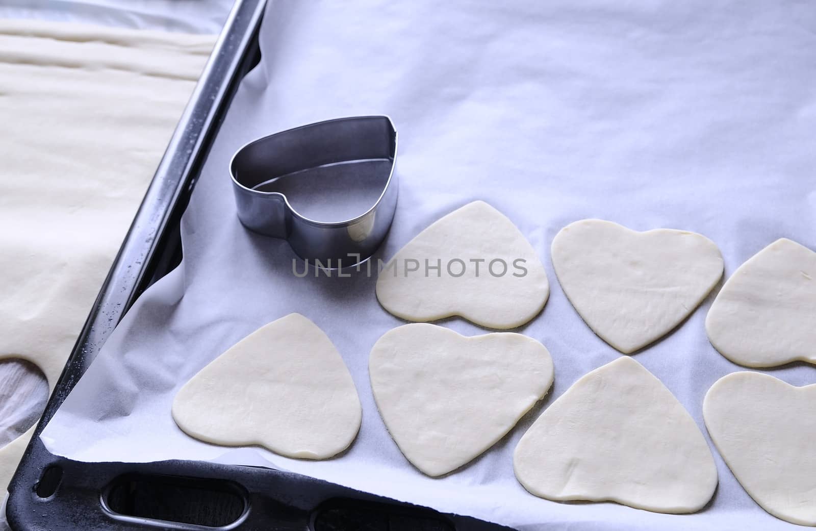 Heart-shaped puff pastry for valentines day over wooden table