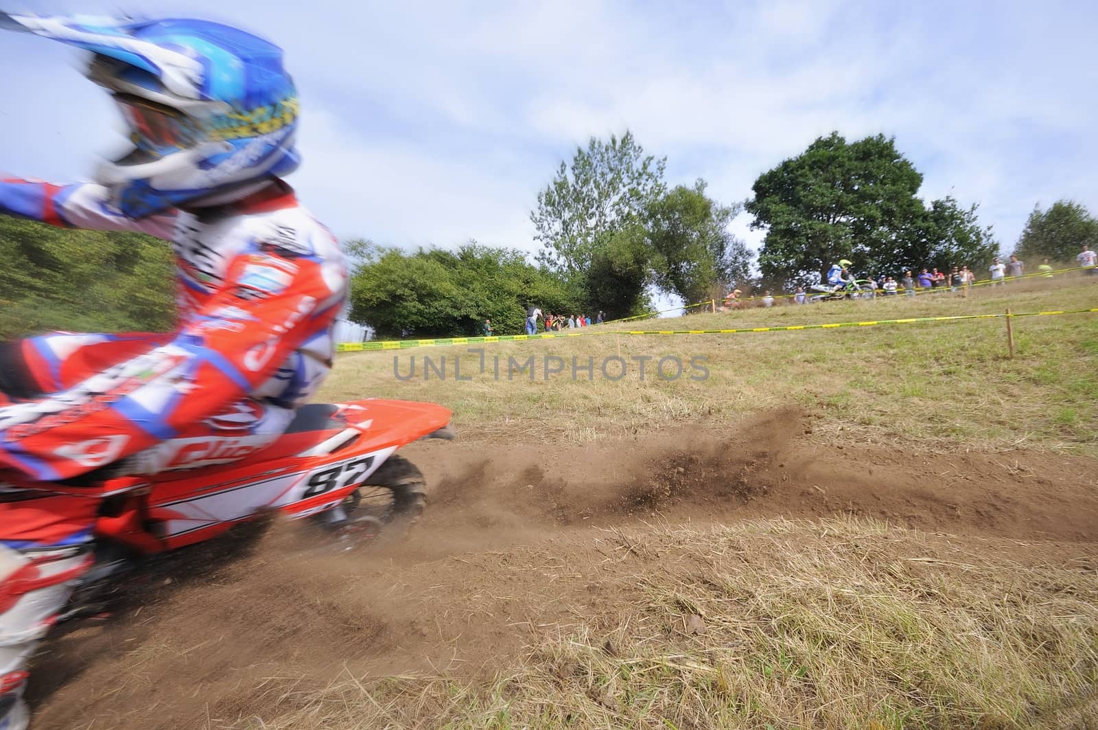 Motocross rider on a muddy track