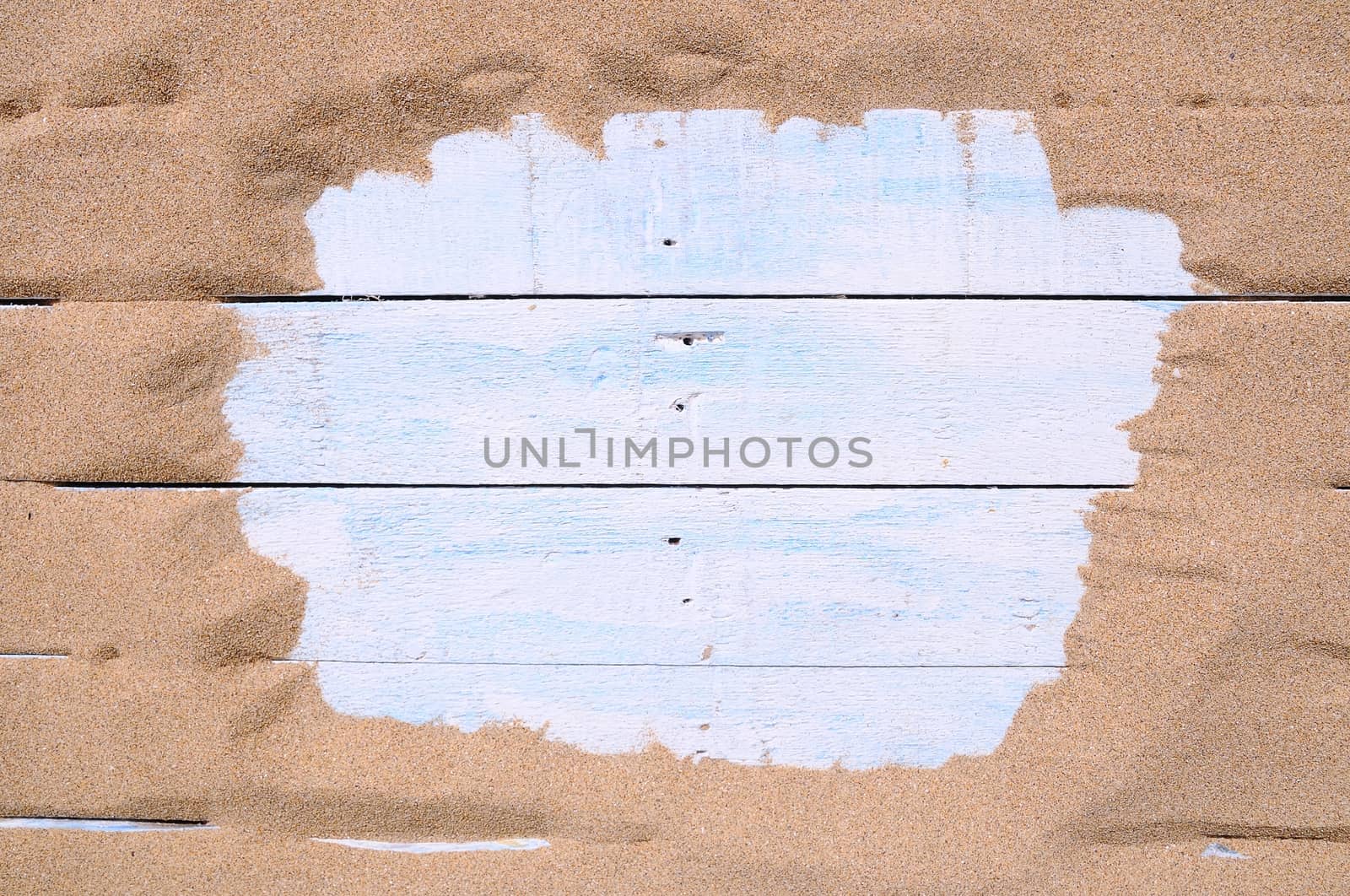 Blue wood surrounded by sand on the beach with space for text entry
