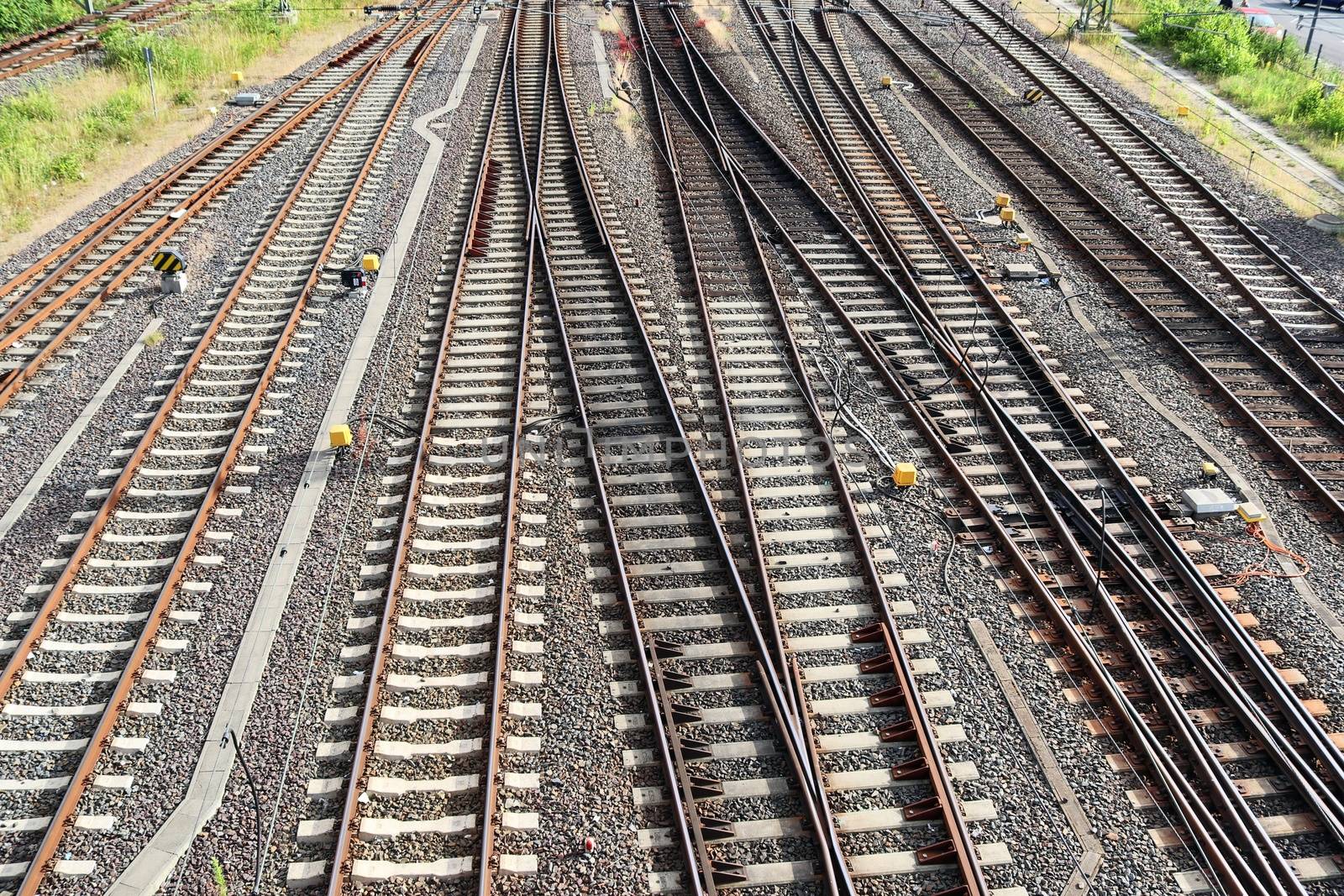 Multiple railroad tracks with junctions at a railway station in  by MP_foto71