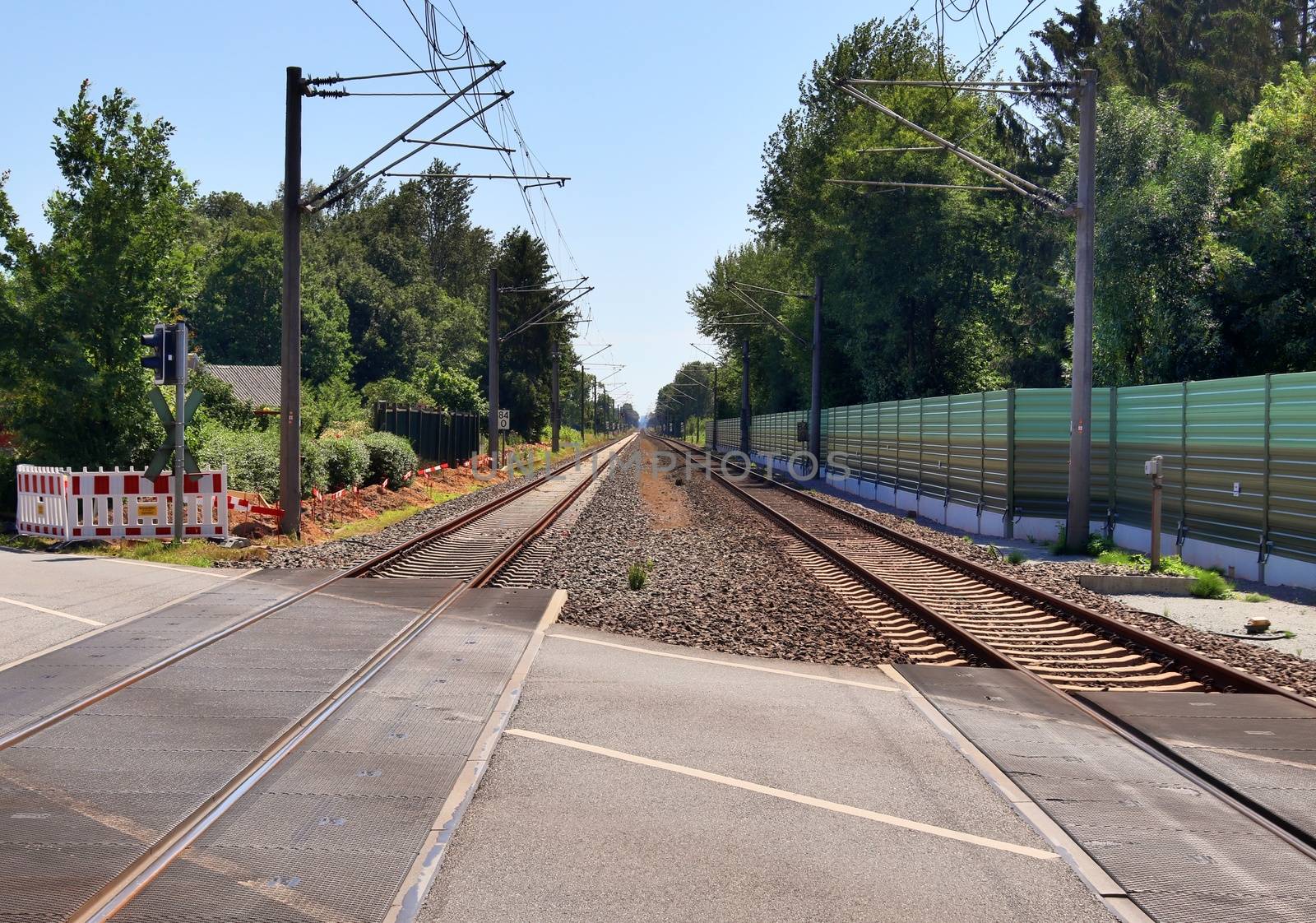 Multiple railroad tracks with junctions at a railway station in a perspective view