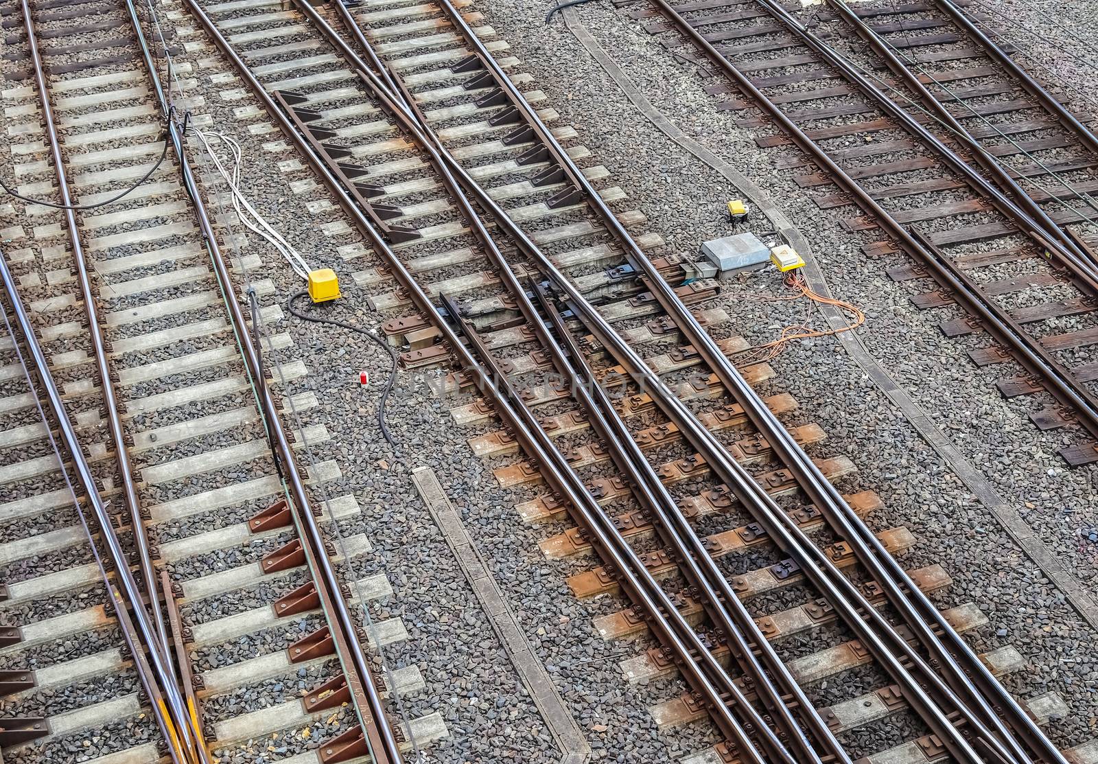 Multiple railroad tracks with junctions at a railway station in  by MP_foto71