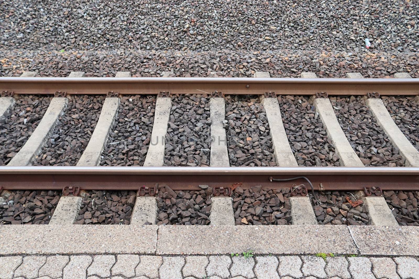 Multiple railroad tracks with junctions at a railway station in a perspective view