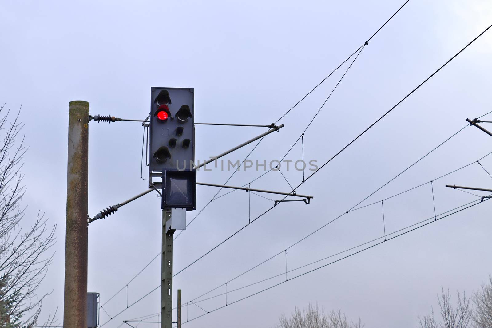 Multiple railroad tracks with junctions at a railway station in a perspective view