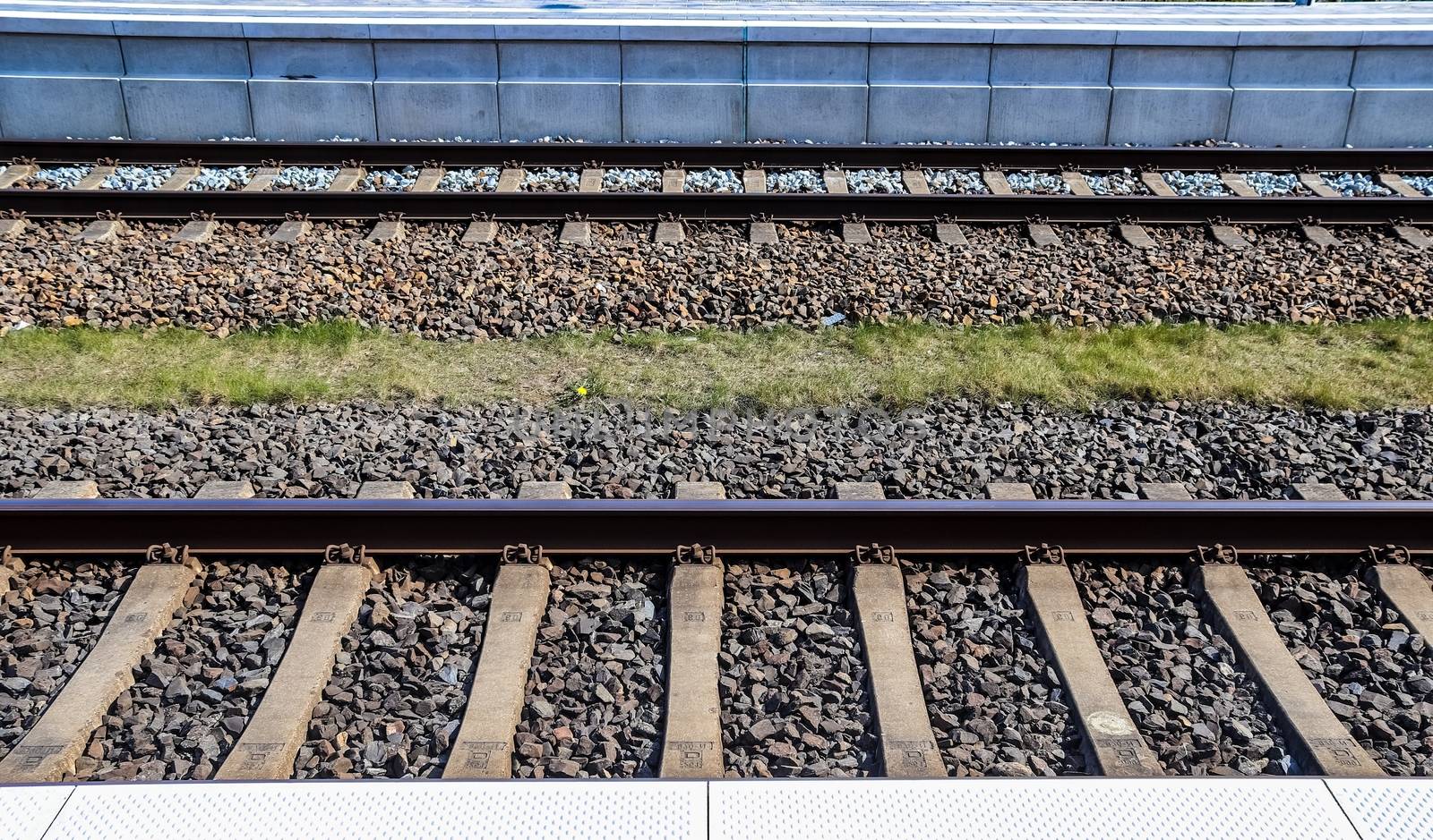 Multiple railroad tracks with junctions at a railway station in a perspective view