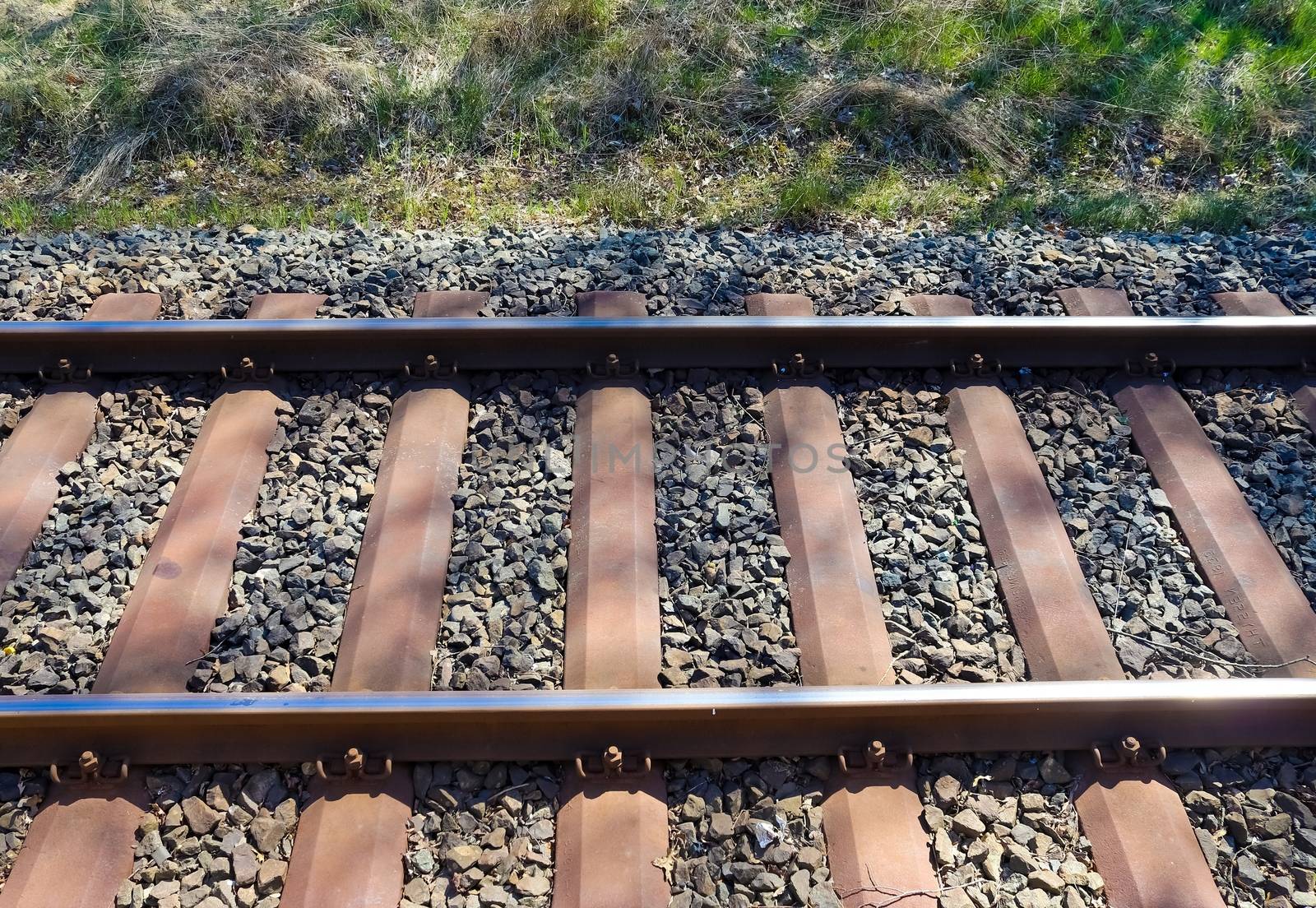 Multiple railroad tracks with junctions at a railway station in a perspective view