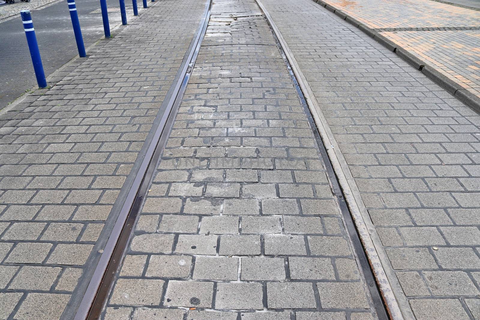 Multiple railroad tracks with junctions at a railway station in a perspective view