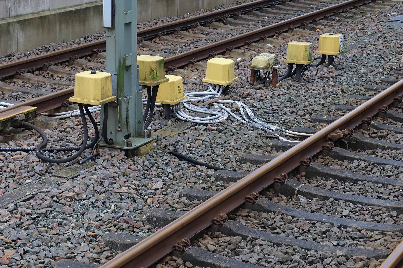 Multiple railroad tracks with junctions at a railway station in a perspective view