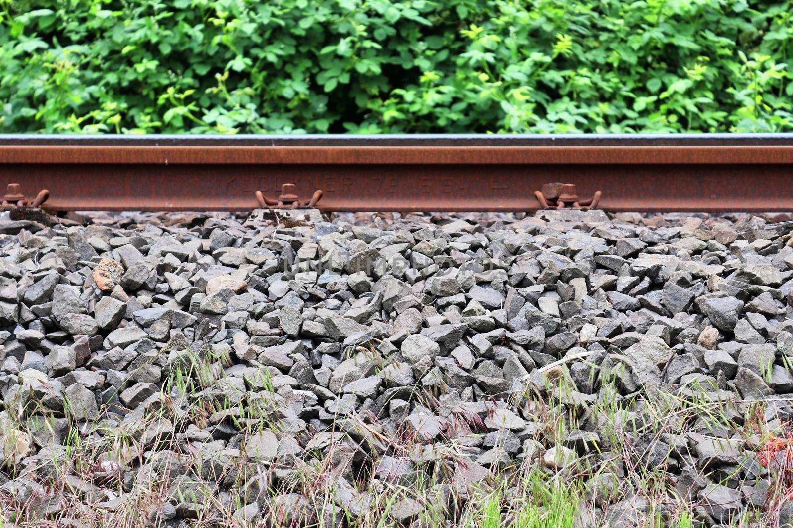 Multiple railroad tracks with junctions at a railway station in a perspective view