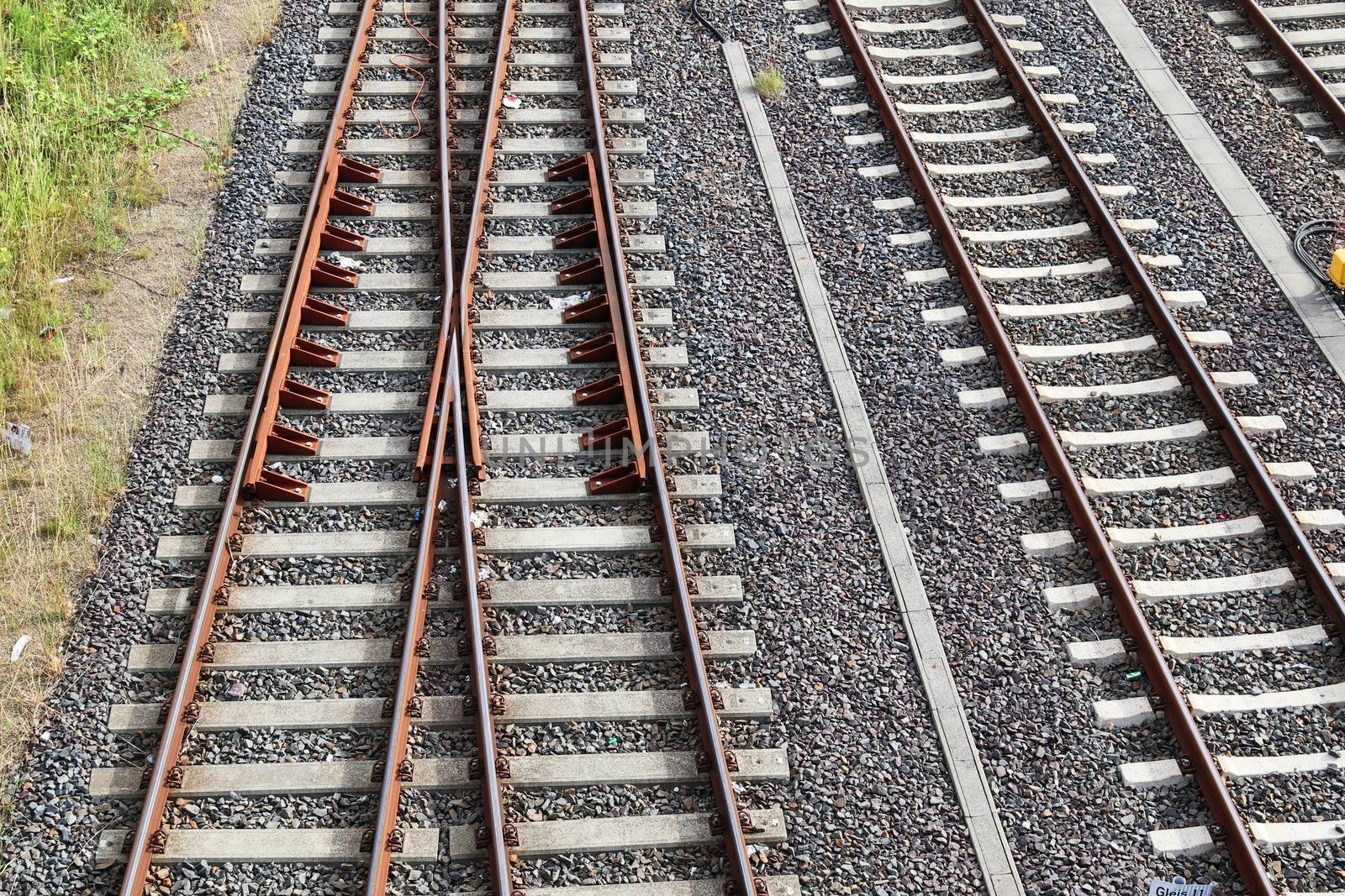 Multiple railroad tracks with junctions at a railway station in  by MP_foto71