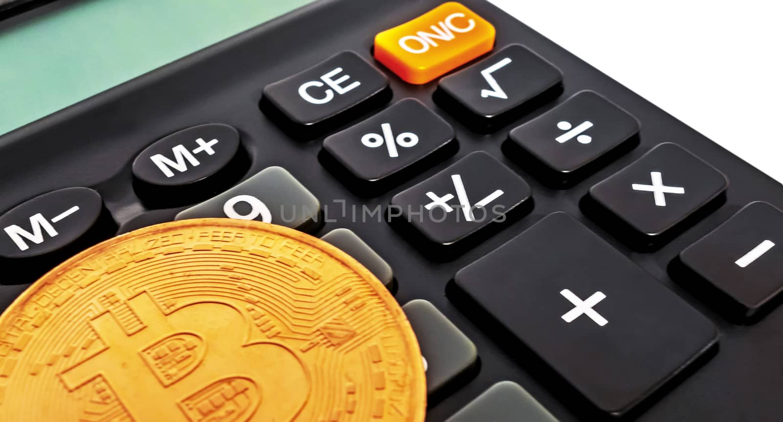 Gold bitcoin coin Business concept Black electronic calculator isolated on white background.