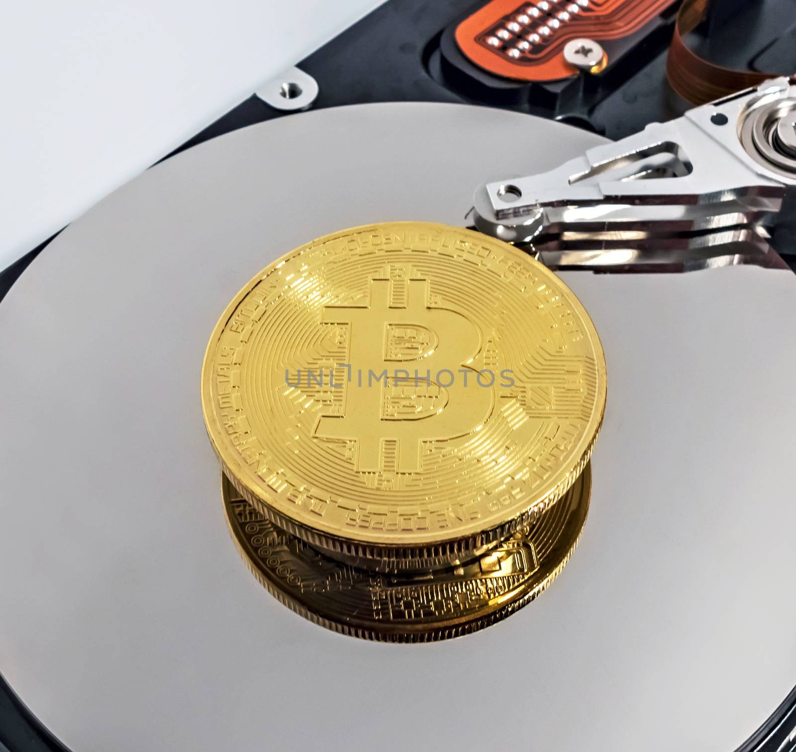 Physical Coin Cryptocurrency BTC Gold Plated Bitcoin in laptop hard disk server. Crypto currency blockchain Coin virtual money concept isolated on white background.