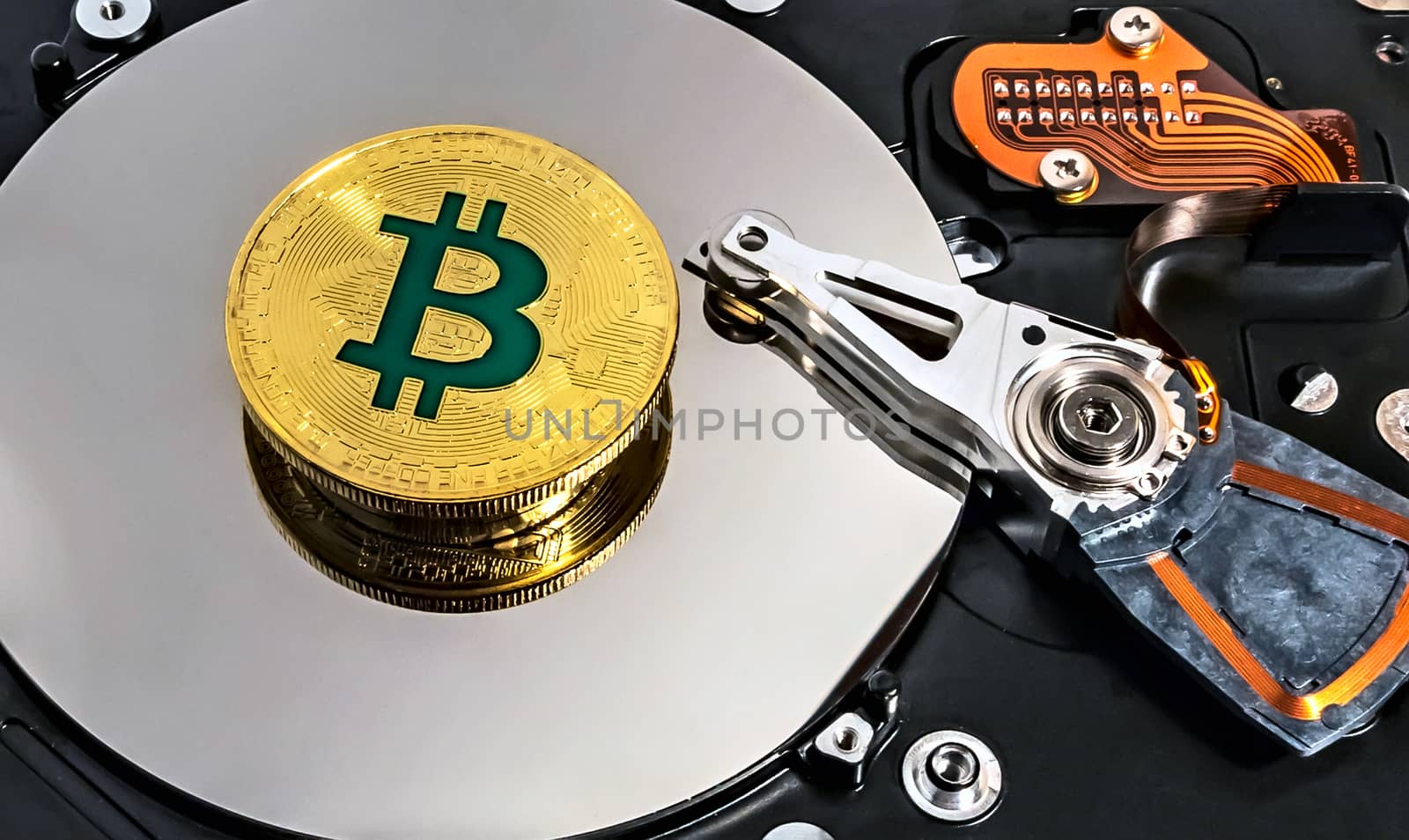 Open computer hard disk drive HDD background BTC Gold Plated Bitcoin Coin