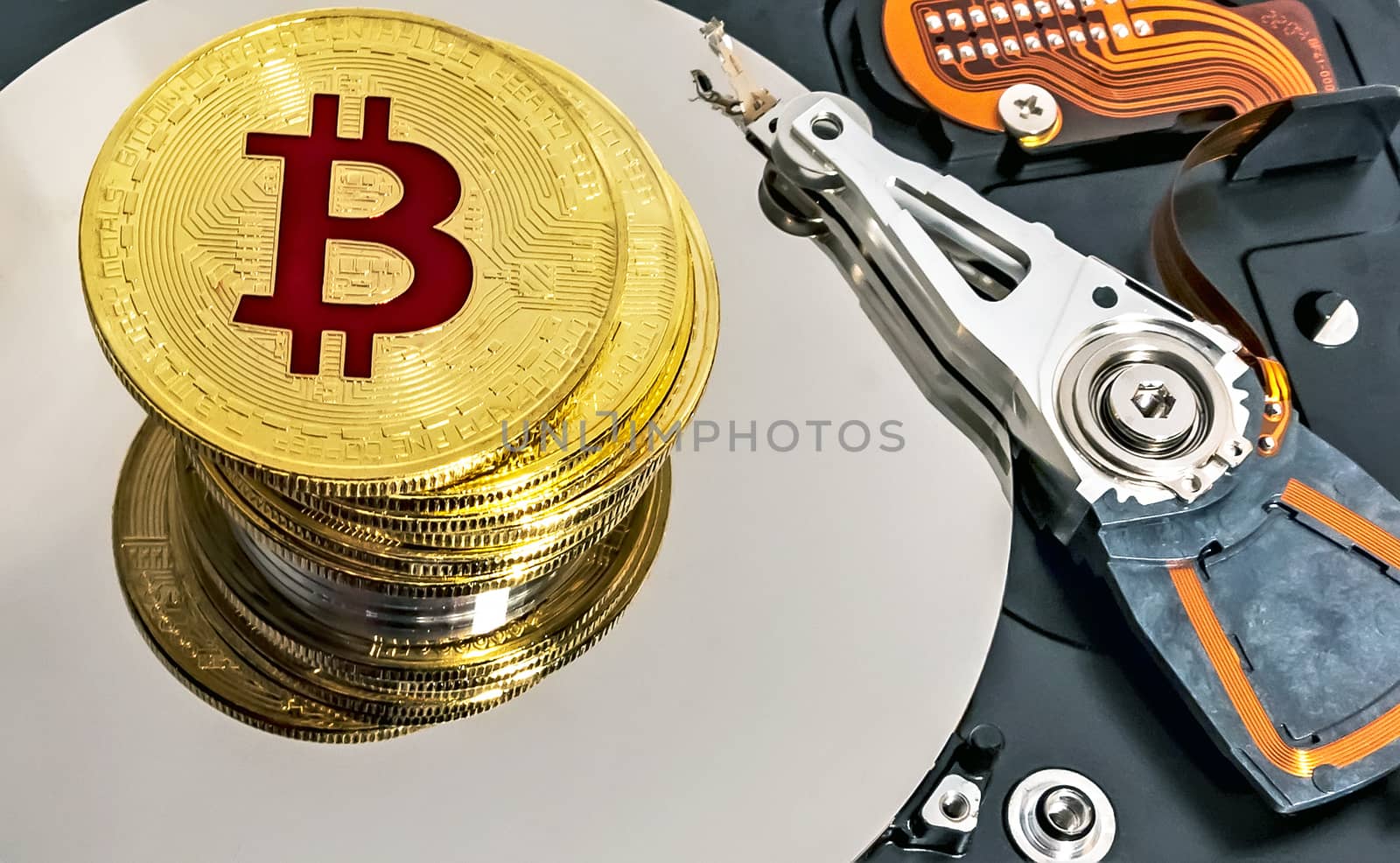 Open computer hard disk drive HDD background BTC Gold Plated Bitcoin Coin
