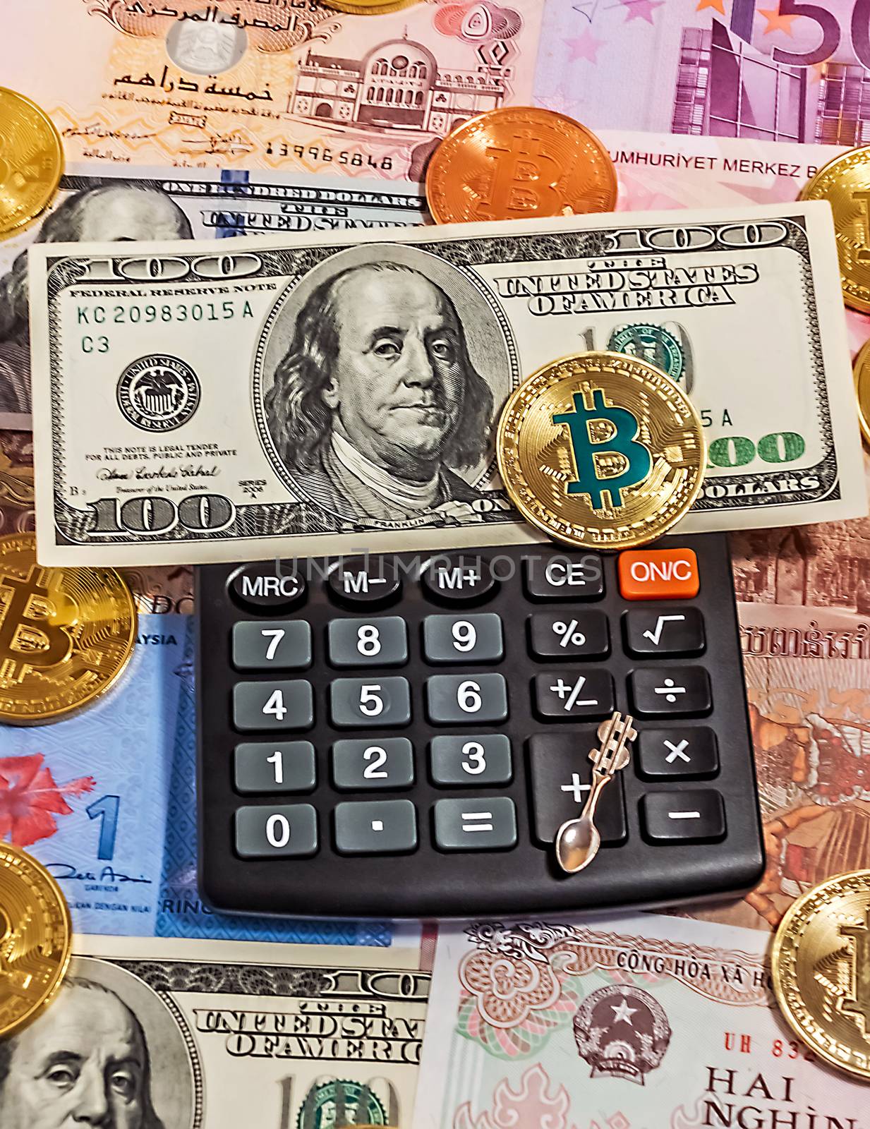 Gold Bitcoin Blockchain technology Black electronic calculator money one hundred dollar bill background