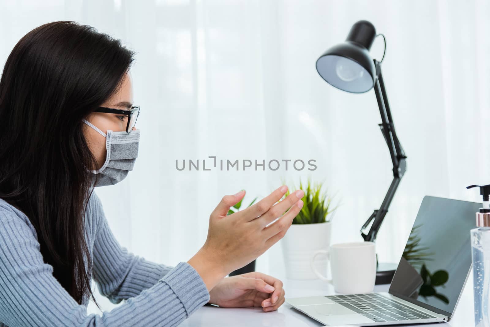 Business woman wearing face mask protective working from home of by Sorapop