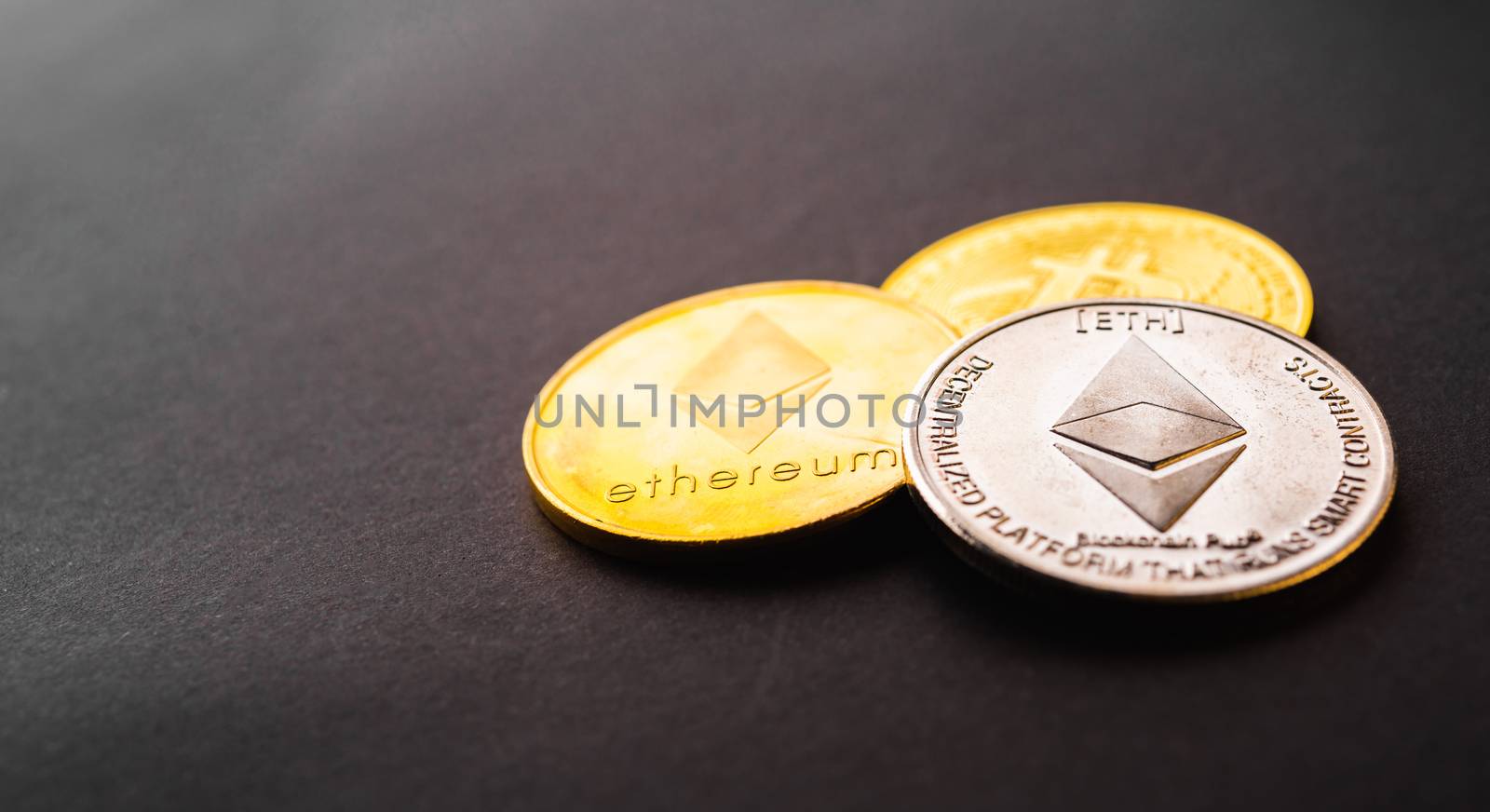 Golden ether coins or Ethereum network exchange on black background, blockchain and money cryptocurrency (crypto currency) concept