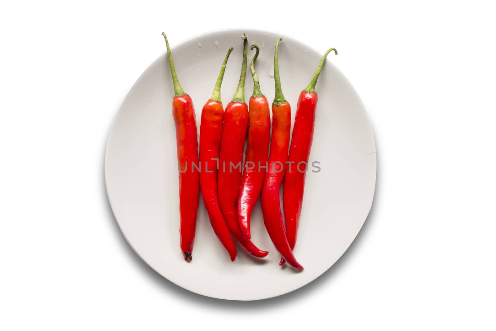 Red chilli pepper on white dish on white background,overhead