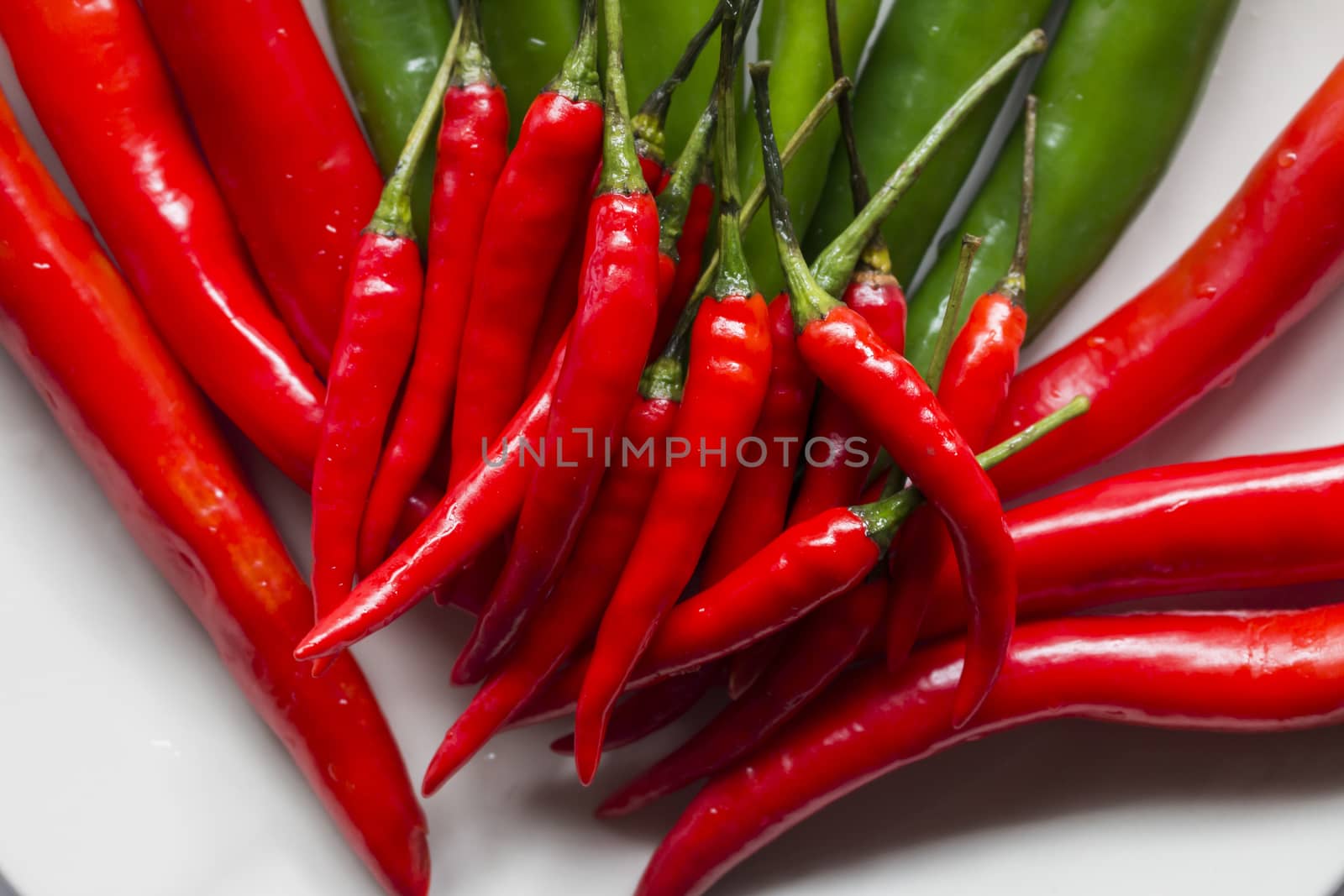 Small red chilli pepper on big chilli pepper,food background