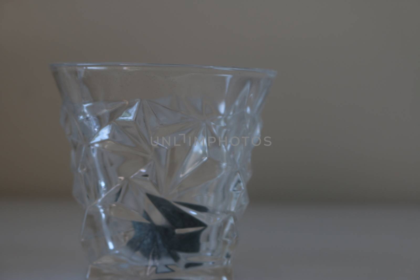A whiskey glass with a whiskey stone inside it.  by mynewturtle1