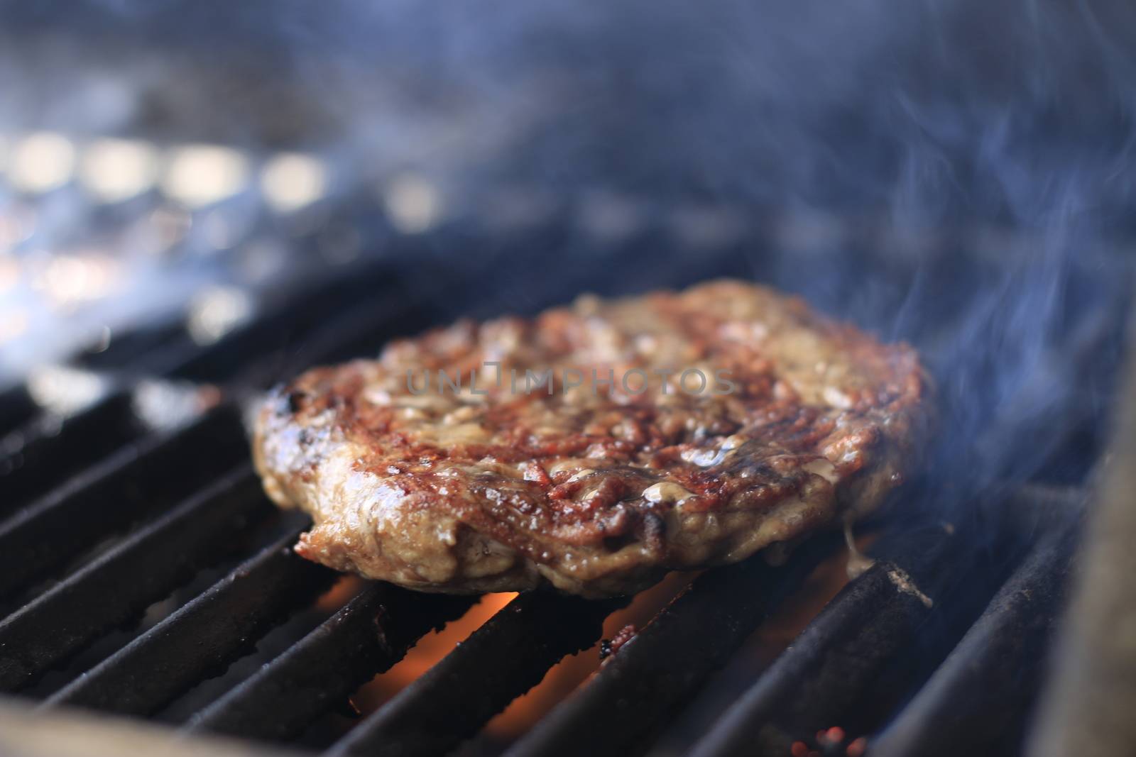 Burgers. Hamburgers being flame broiled on the gas grill by mynewturtle1
