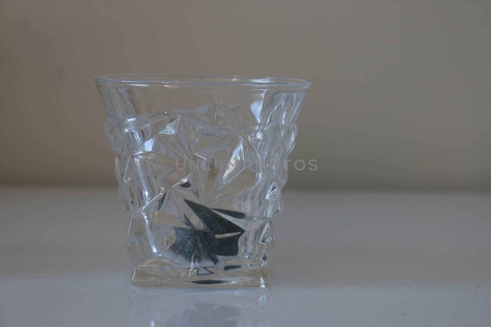 Whiskey glass and stone, studio stock photo 