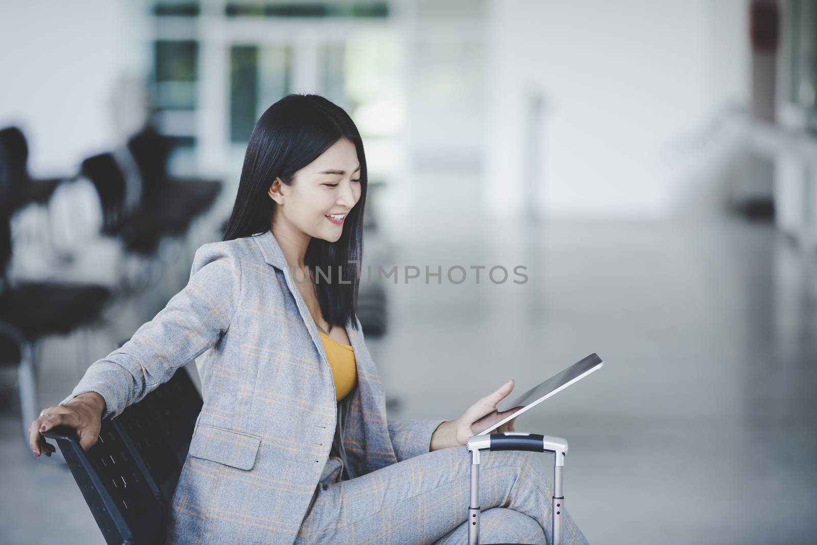 Portrait of business woman looking digital tablet with white tra by numberone9018