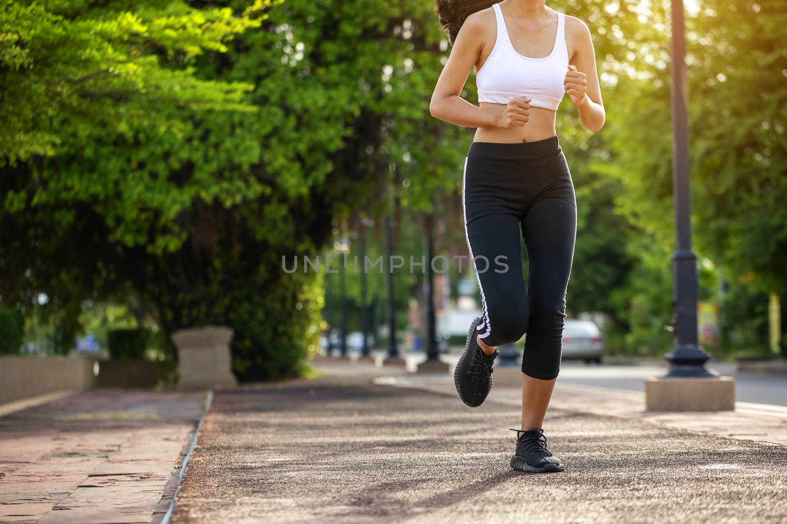 Beautiful woman jogger outdoor living healthy lifestyle in city park. Concept sport and a healthy lifestyle in the city
