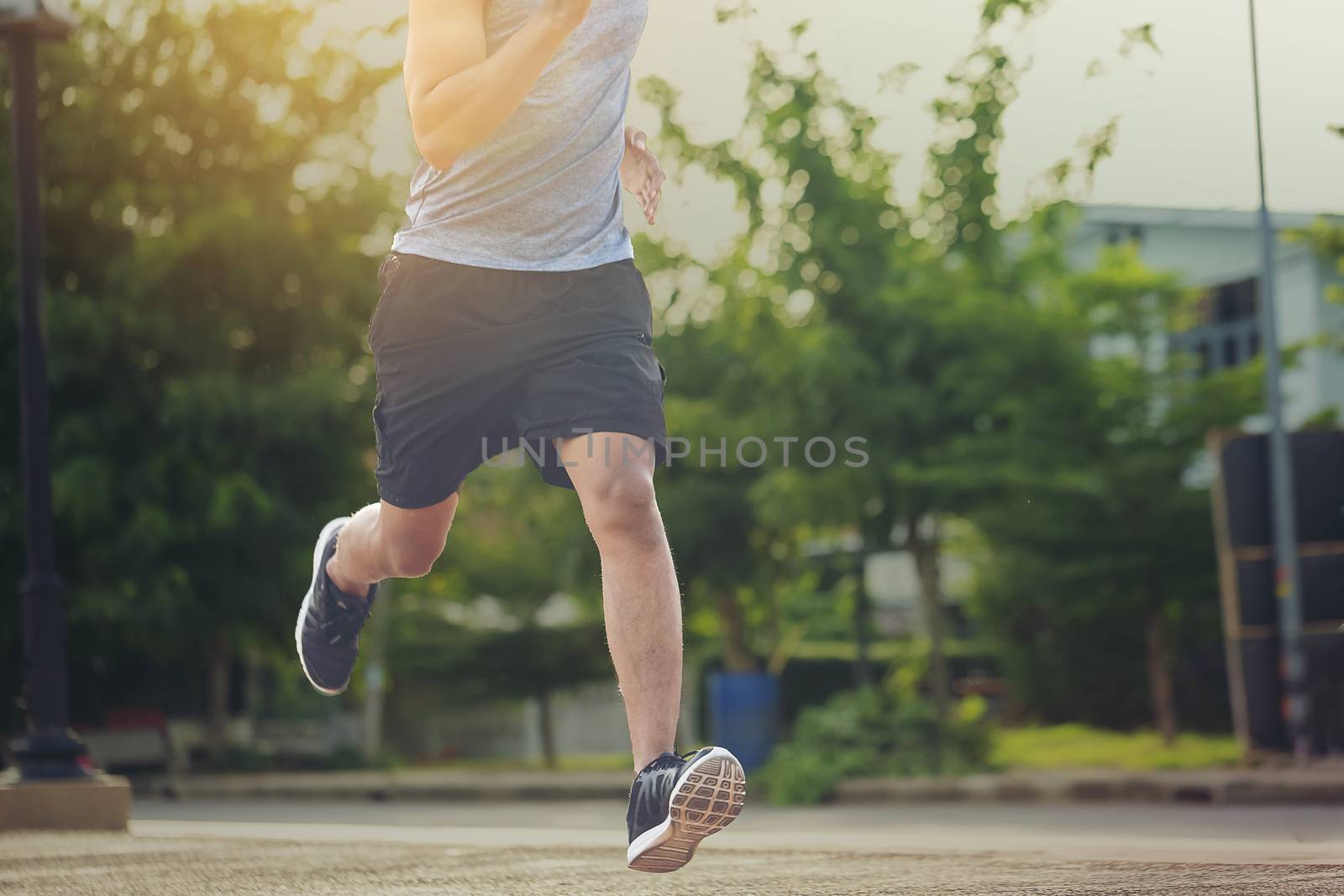 Portrait of fit and sporty young man running in the city. Concept sport and a healthy lifestyle in the city