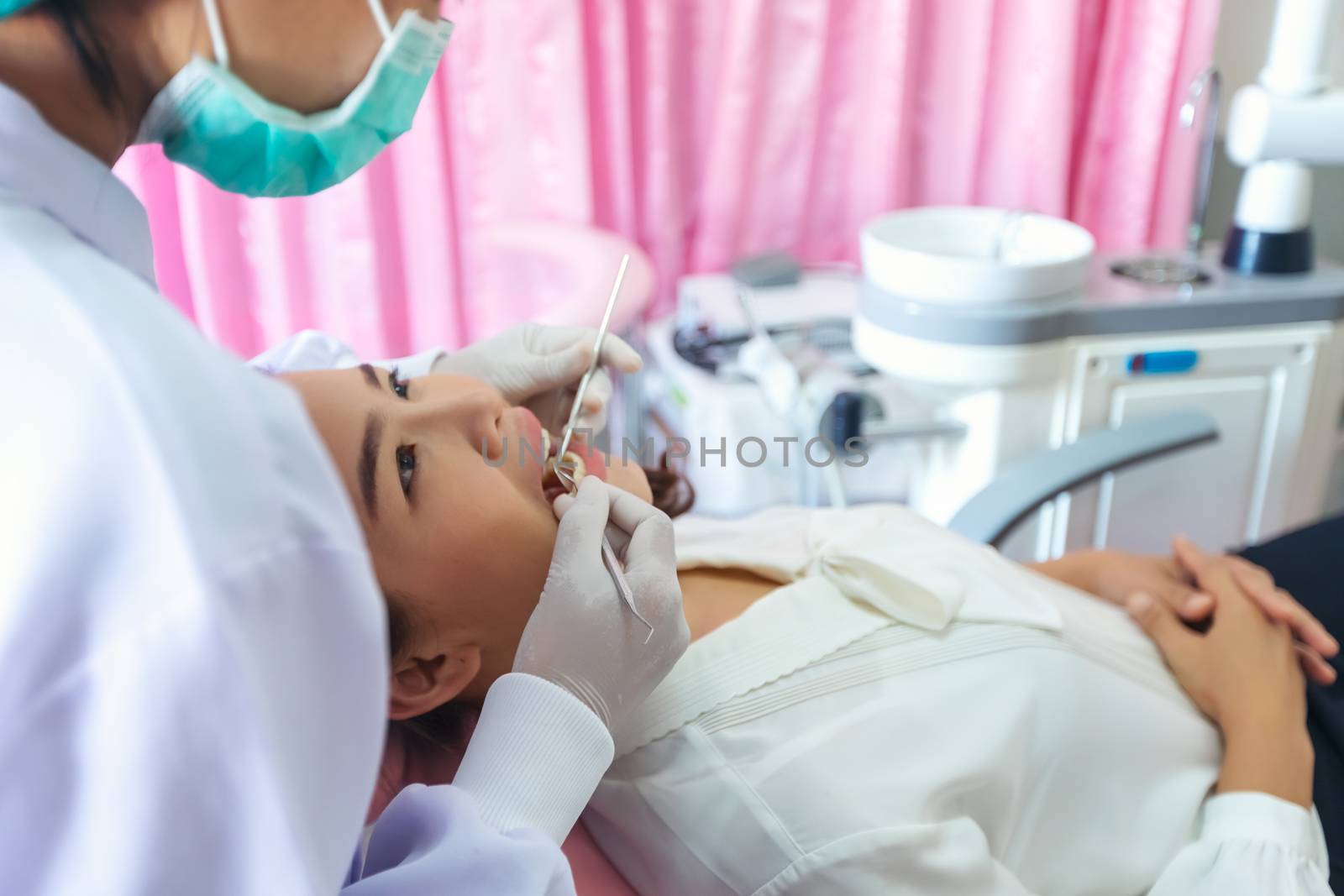 A beautiful woman giving the dentist a dental and oral examination For healthy mouth and teeth